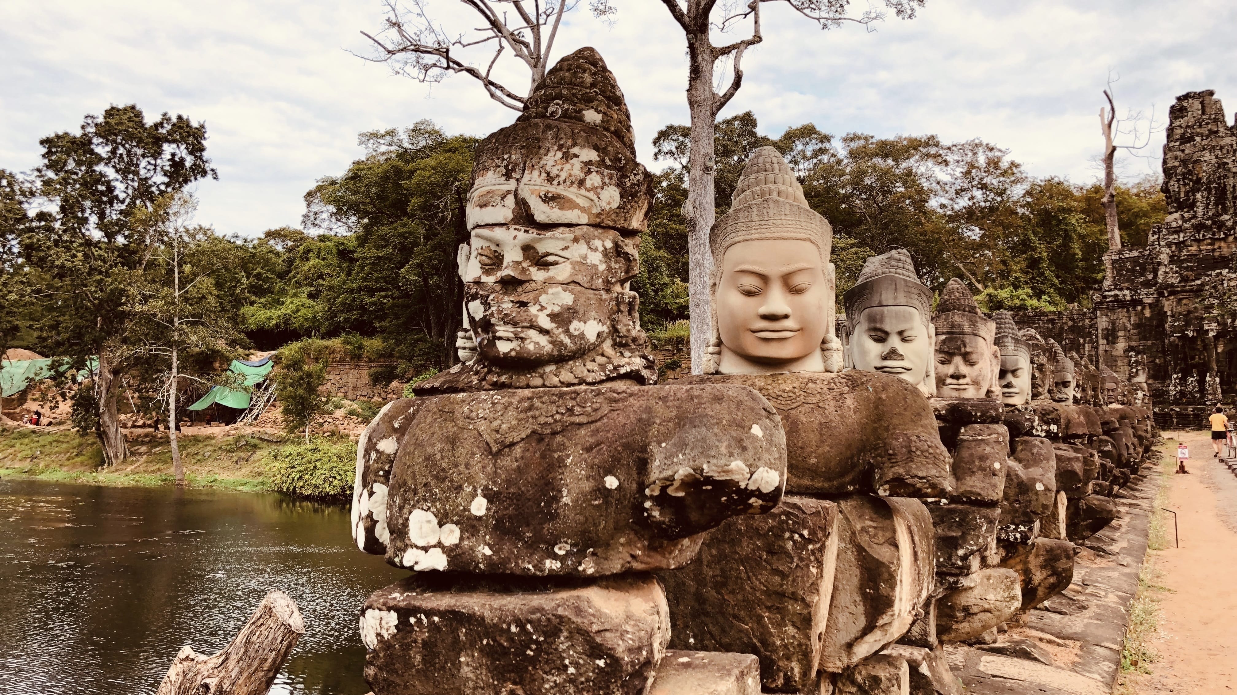 Stone faces lining the causeway at Angkor Thom in Cambodia, part of the ancient Angkor temple complex, photographed during a five-day Cambodia itinerary.