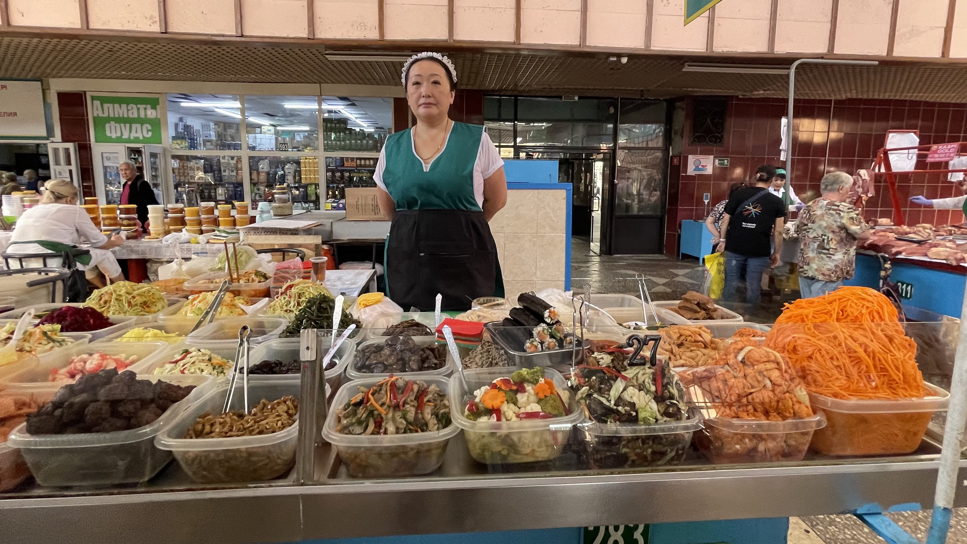 Prepared salads, pickled vegetables, and Korean-style banchan for sale at a vendor stall in Almaty’s Green Market during a 2 days in Almaty visit