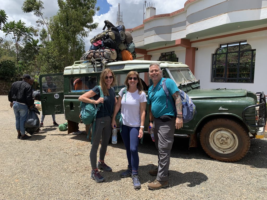 Mount Kenya hiking group with gear and Land Rover at the Chogoria trailhead.