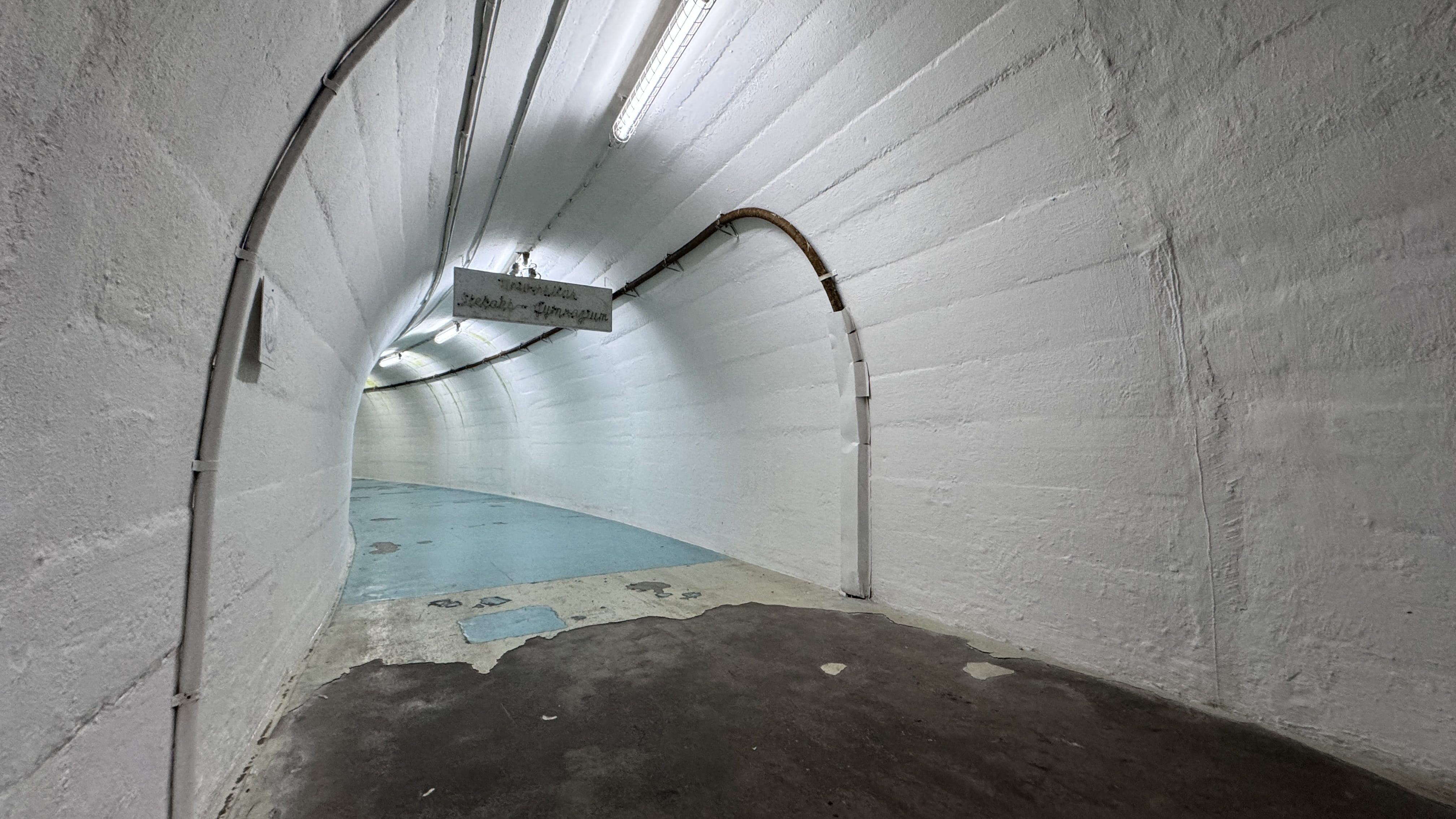 Curved white hallway inside the entrance to Tito’s secret Cold War bunker