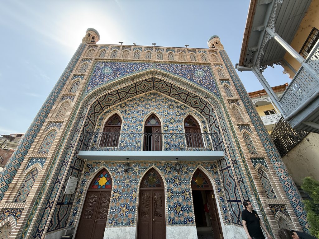 Ornate Persian-style facade of Orbeliani, one of Tbilisi’s sulfur baths, decorated with colorful mosaic tiles.