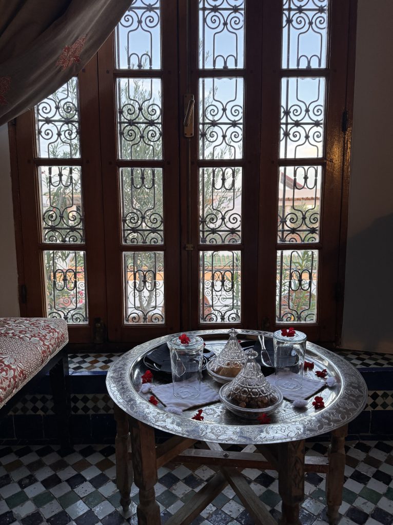 raditional Moroccan tea service on a silver tray inside a guest room at Eden at Palais Amani, with ornate window grilles and tiled floor, captured during 2 Days in Fes.