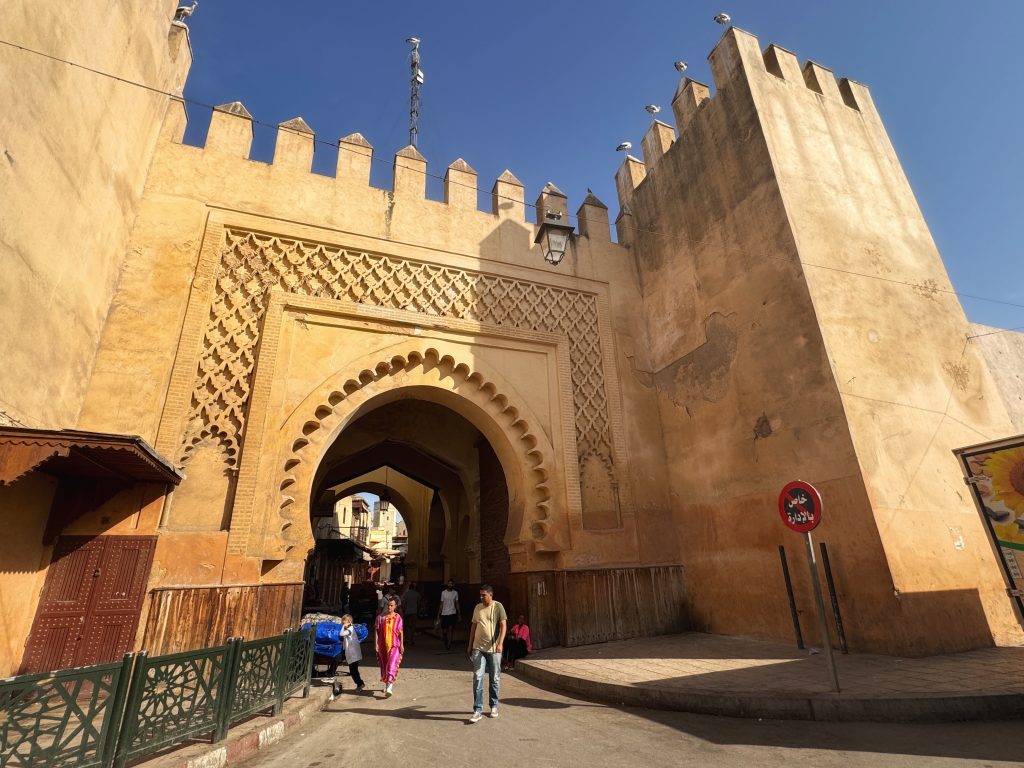 Bab Semmarine, one of the historic gates of Fes el Jdid, with yellow stone walls and pedestrians passing through, photographed during 2 Days in Fes.