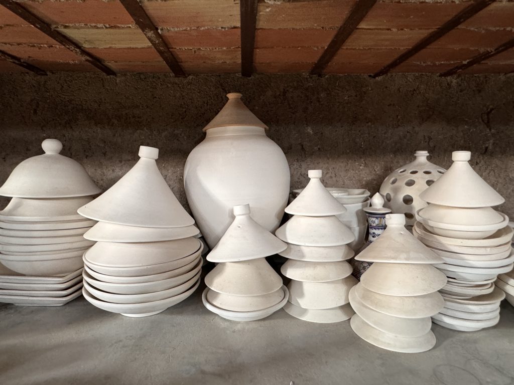 Stacks of unglazed pottery tajines and vessels at a ceramics workshop in Fes, Morocco, visited during 2 Days in Fes.