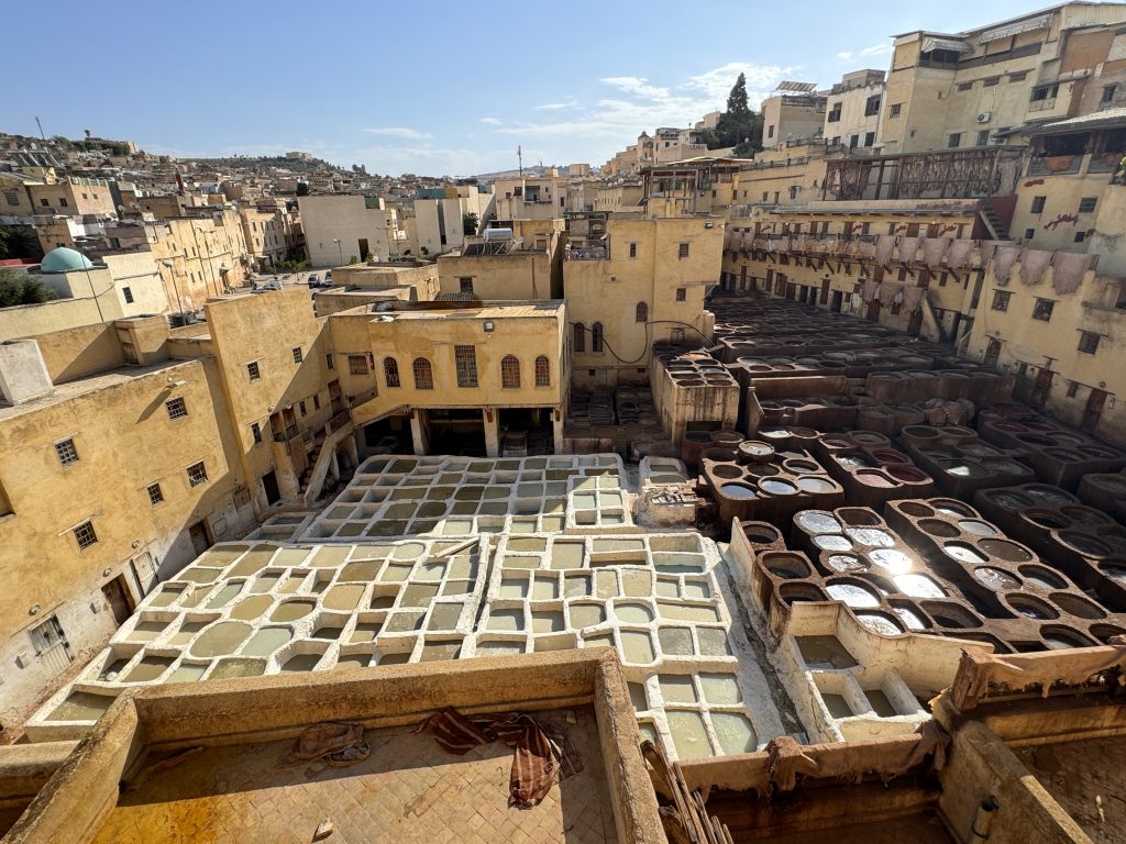 View over the Chouara Tannery in Fes, Morocco, with rows of circular dye vats and yellow-walled buildings, seen during 2 Days in Fes.