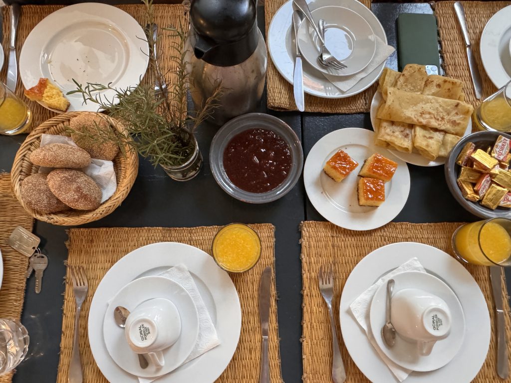 Moroccan breakfast with msemen, semolina cake, bread, jam, and orange juice at Riad Al Jazira, Marrakech—Two days in Marrakech