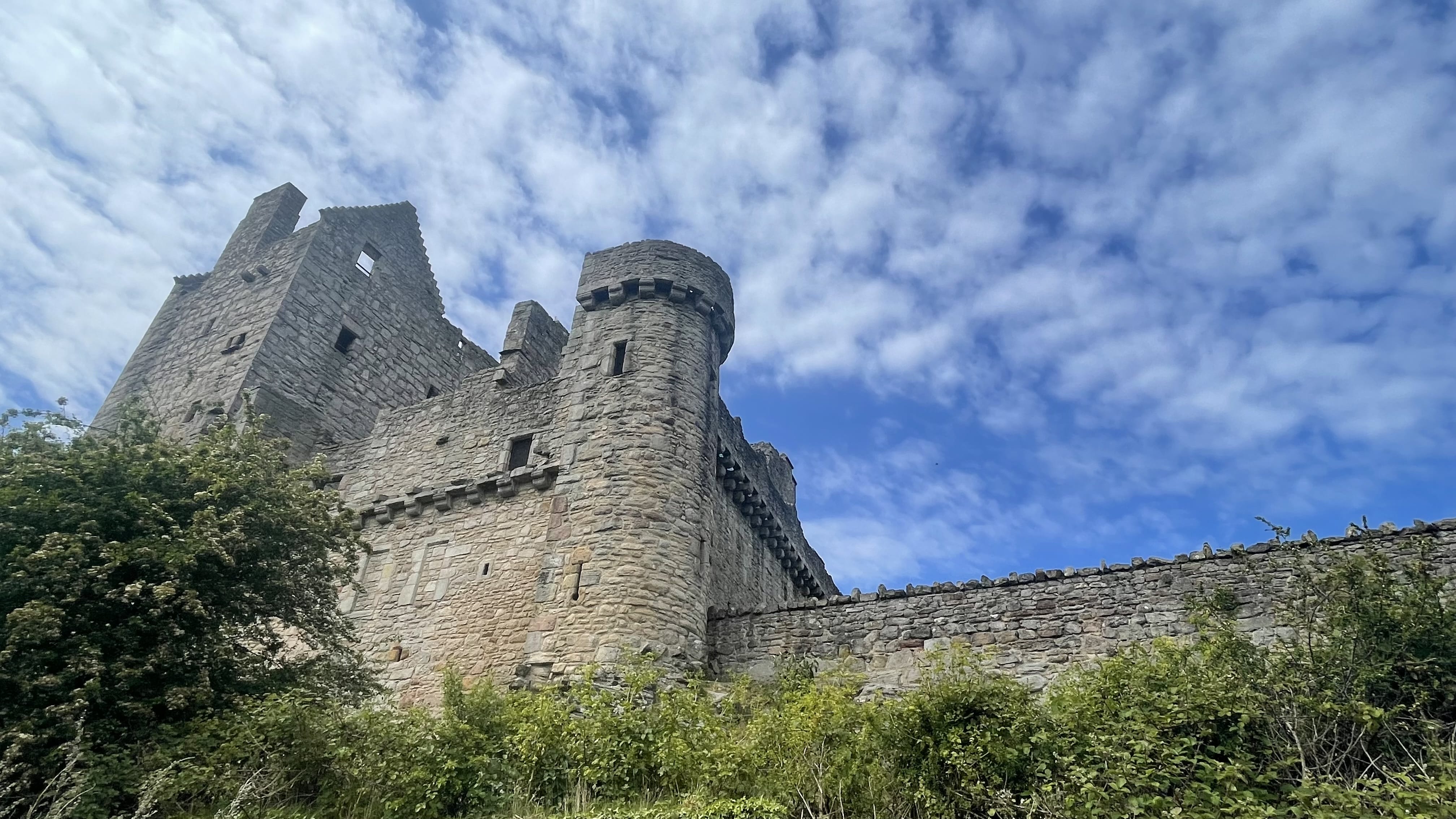 Craigmillar Castle ruins near Edinburgh, seen during 4 days in Edinburgh, with its stone tower rising against a blue sky.