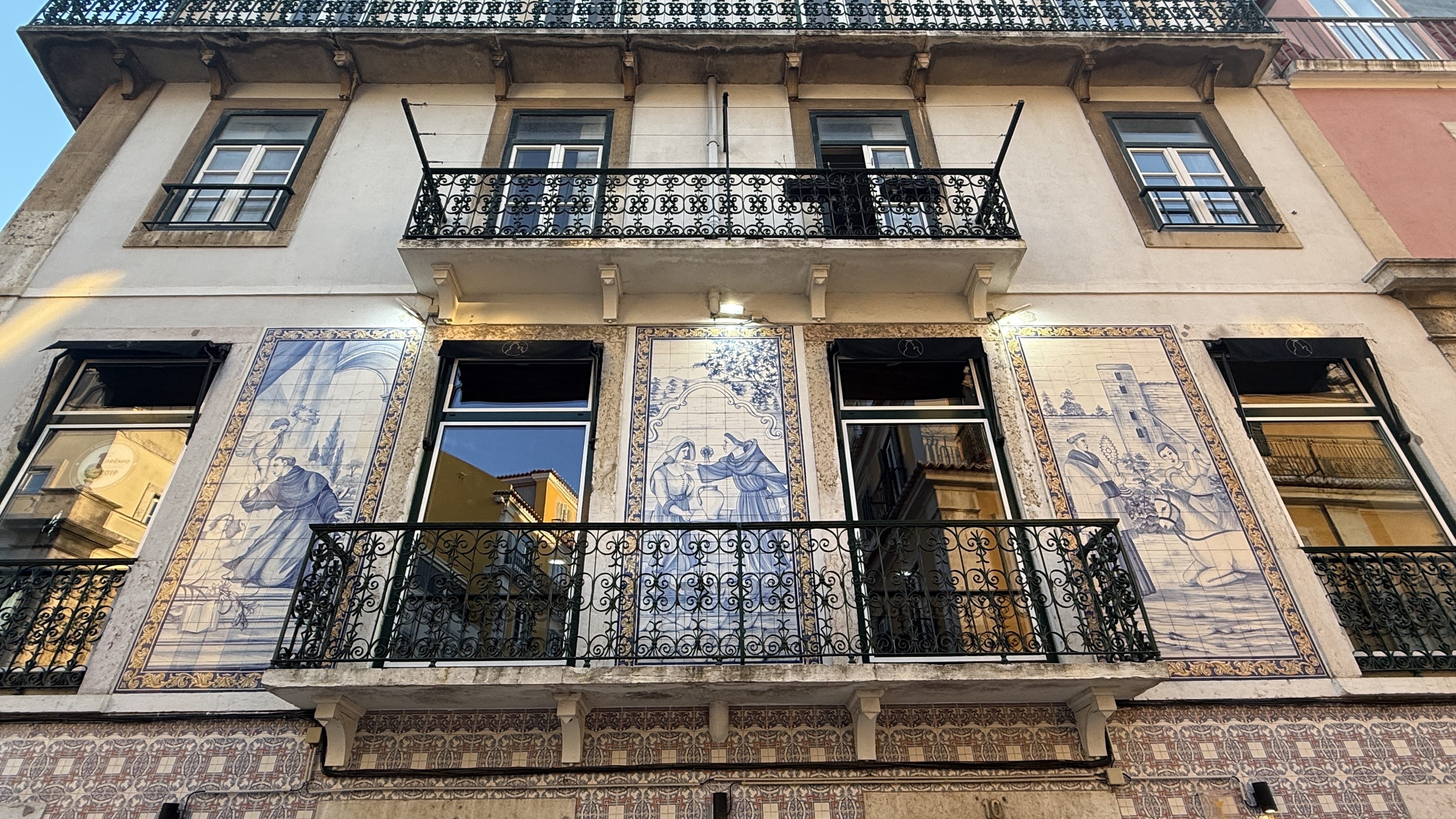 Blue-and-white azulejo tile panels depicting religious scenes on a Lisbon building, taken during 5 Days in Lisbon.