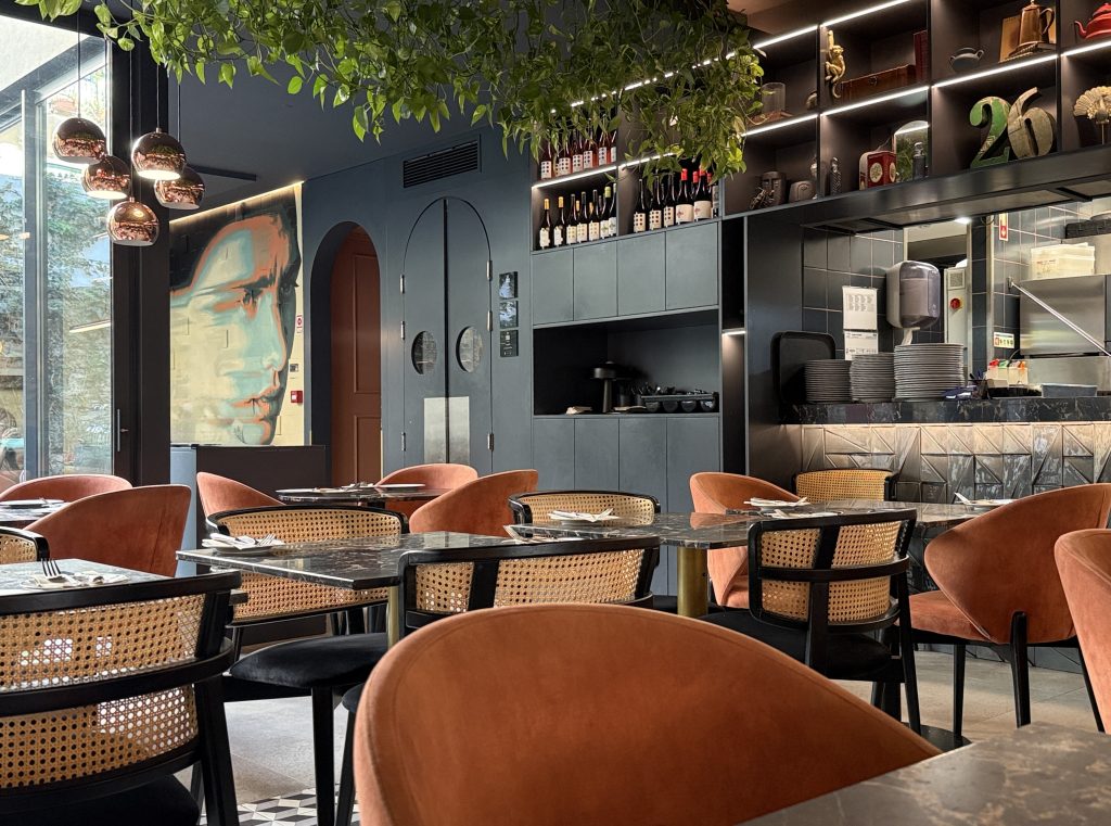 Modern vegan restaurant in Lisbon with mural, sleek decor, and rattan chairs—5 Days in Lisbon