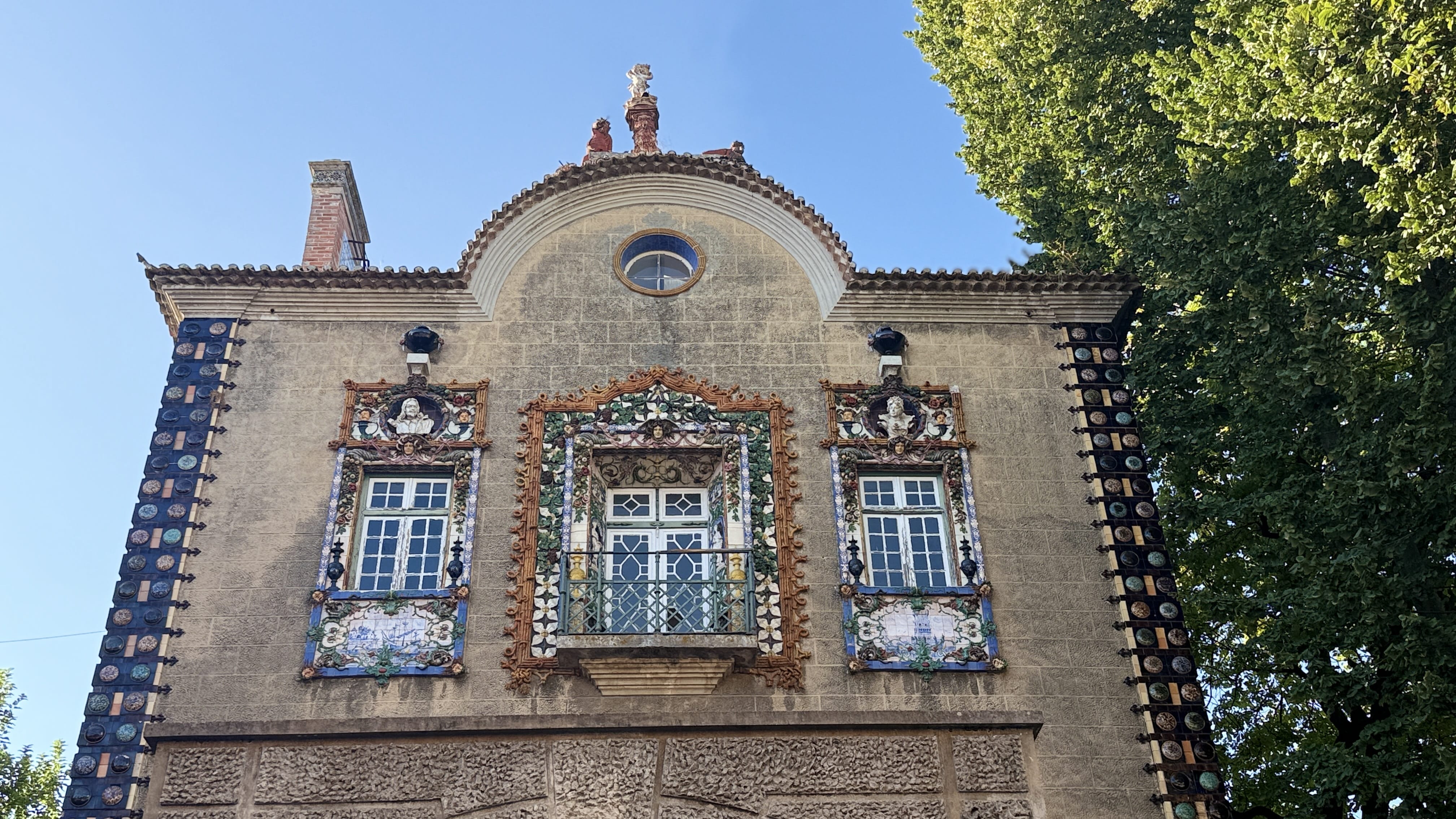 Historic façade with colorful reliefs and ceramic figures surrounding the windows —5 Days in Lisbon