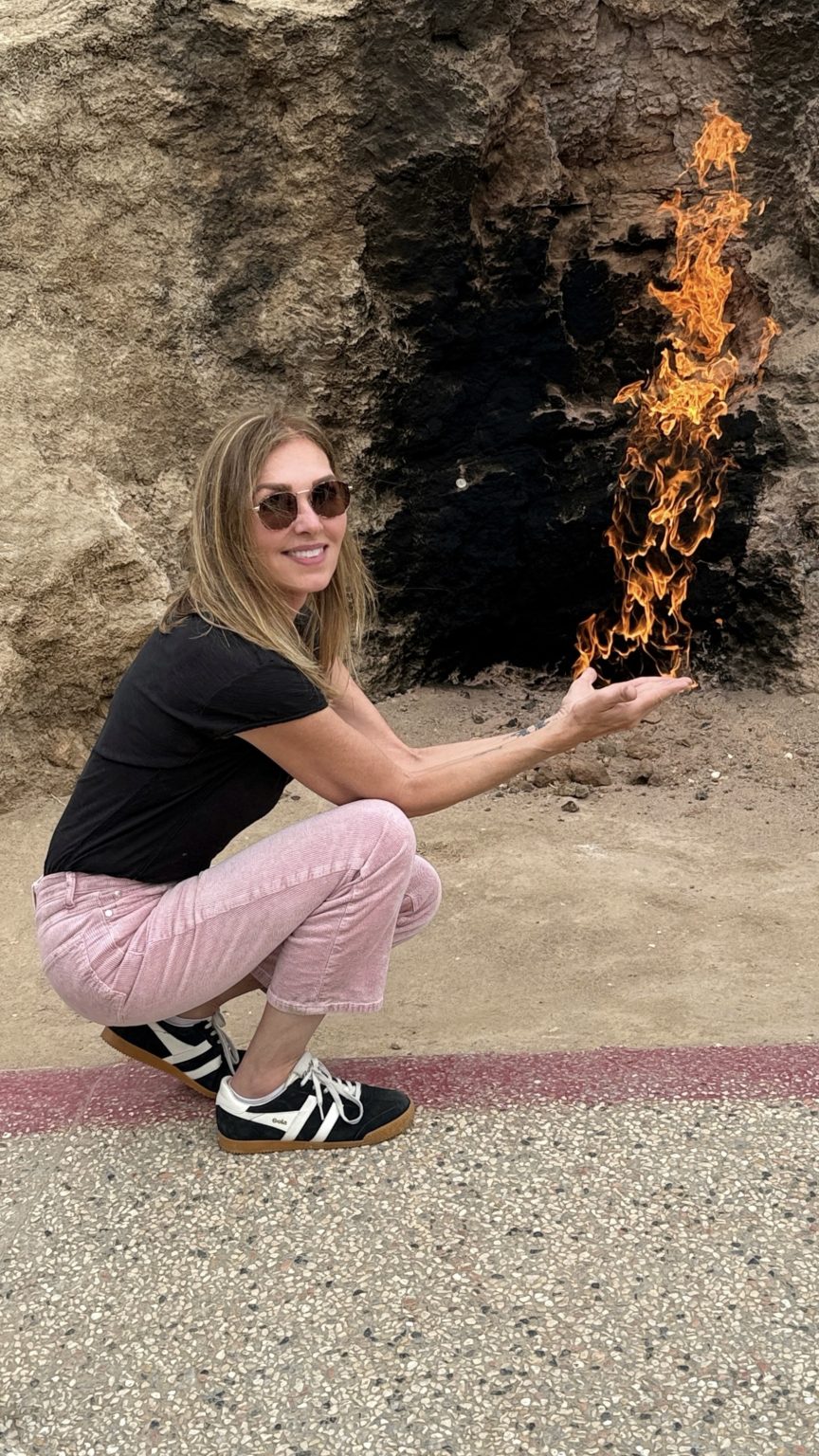 raveler posing near the natural gas flames of Yanardag, the Burning Mountain of Azerbaijan, part of 7 Days in Azerbaijan itinerary.