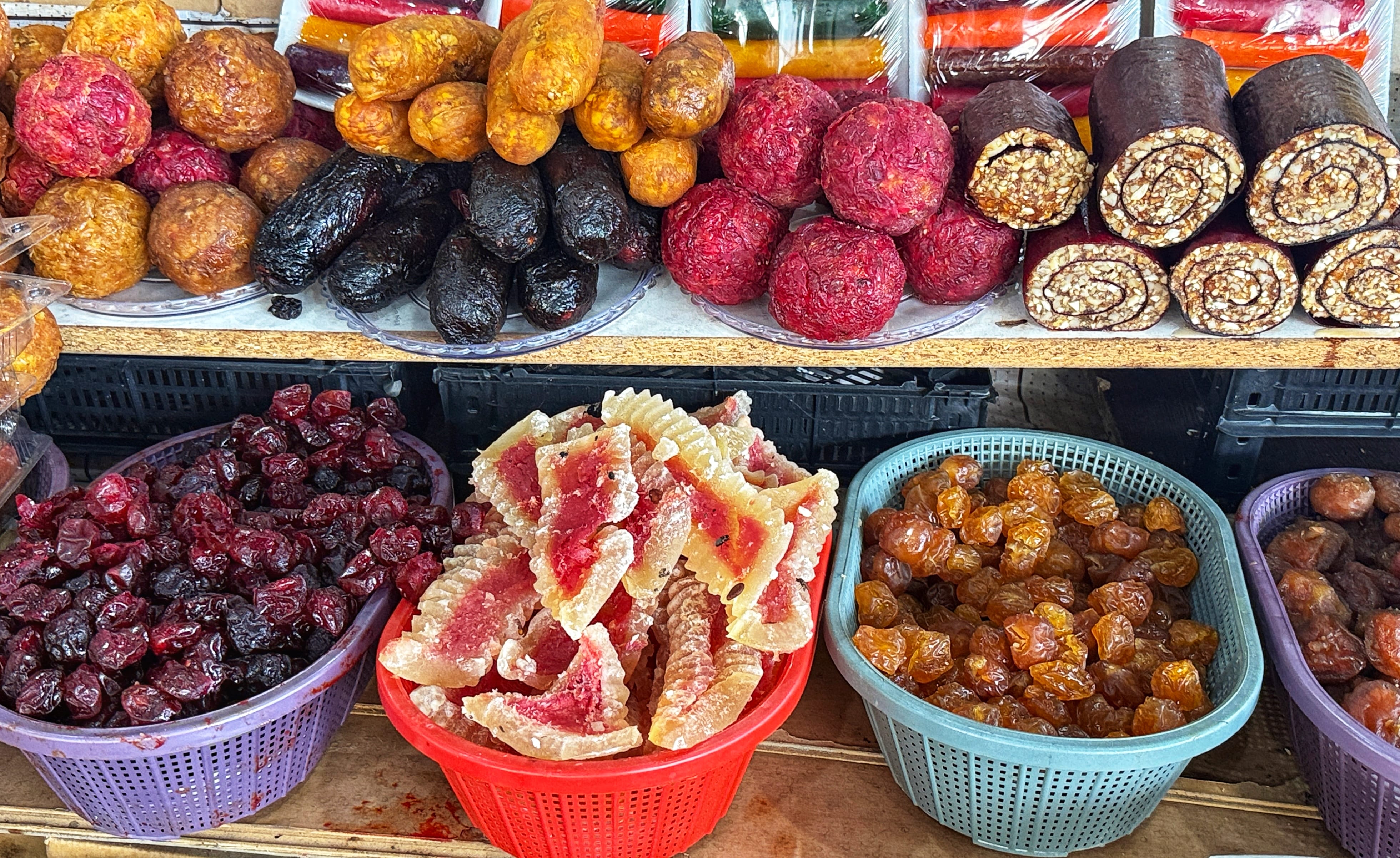 Piles of dried fruits, nuts, and sweets displayed in bulk inside Yerevan’s Gum Market.