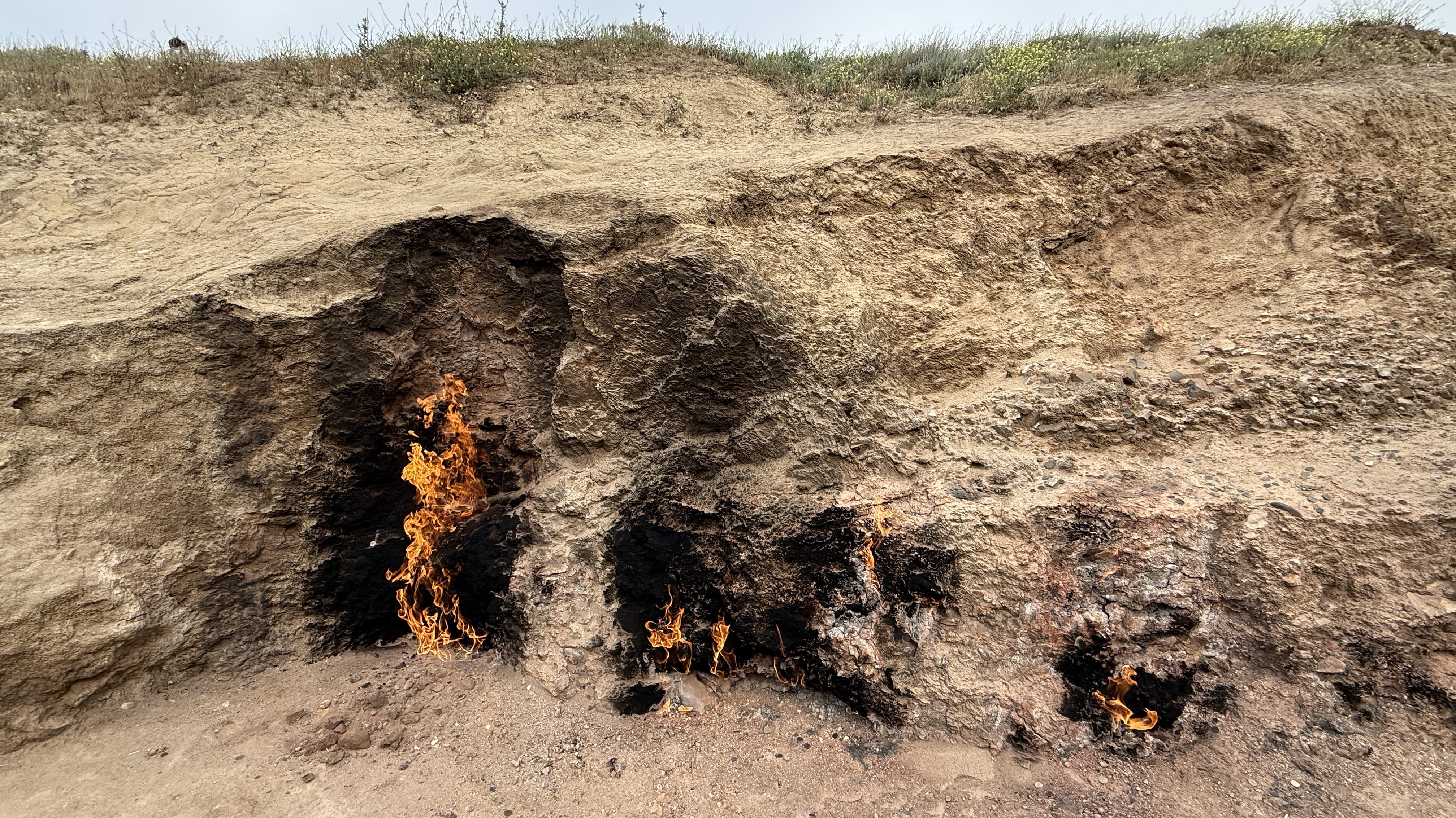 Natural gas flames burning from the hillside at Yanardag, also known as Burning Mountain, near Baku, Azerbaijan — 7 Days in Azerbaijan travel blog.