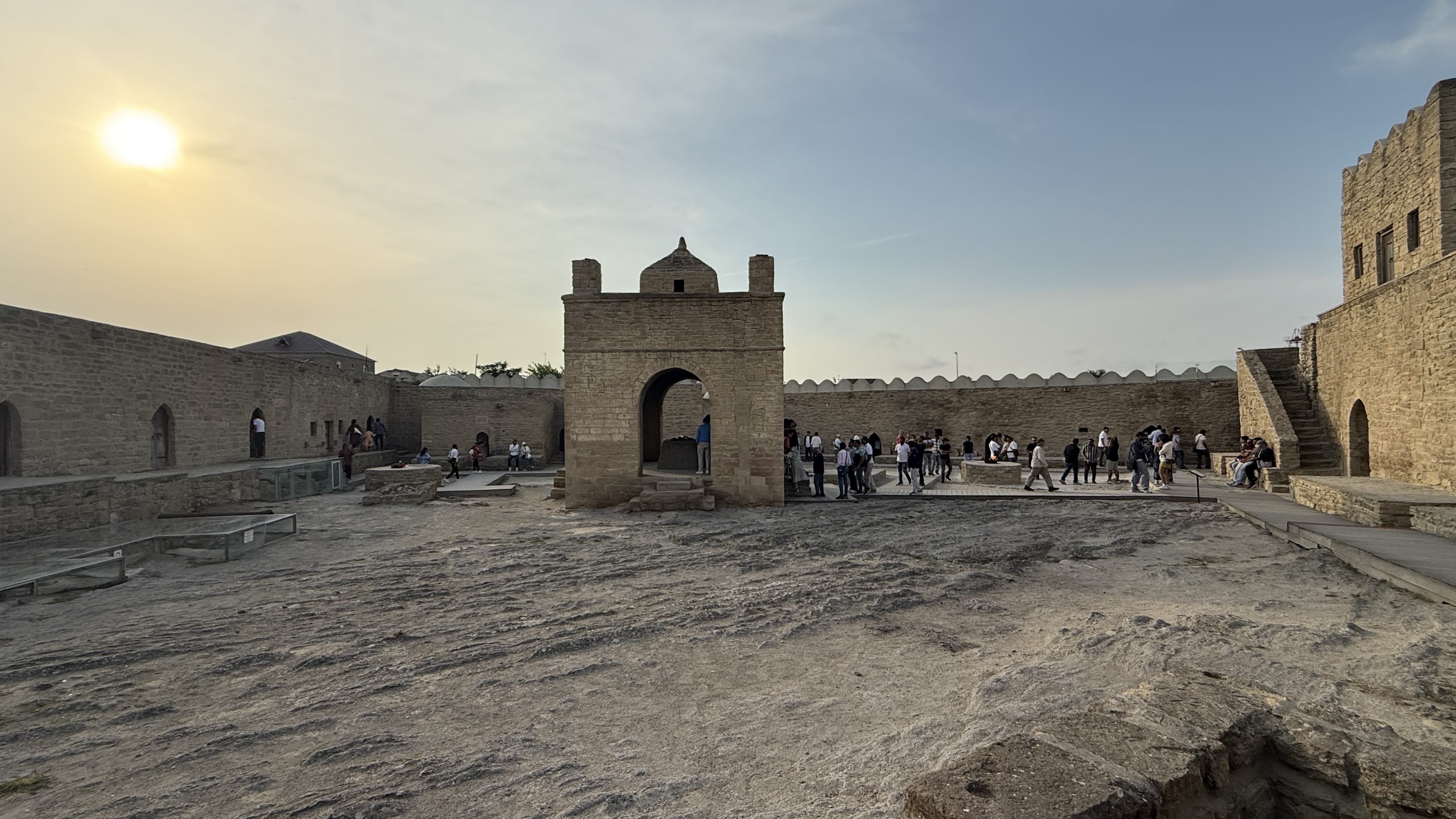 Ateshgah Fire Temple in Surakhani near Baku, Azerbaijan, with visitors exploring the stone courtyard at sunset — 7 Days in Azerbaijan travel blog.