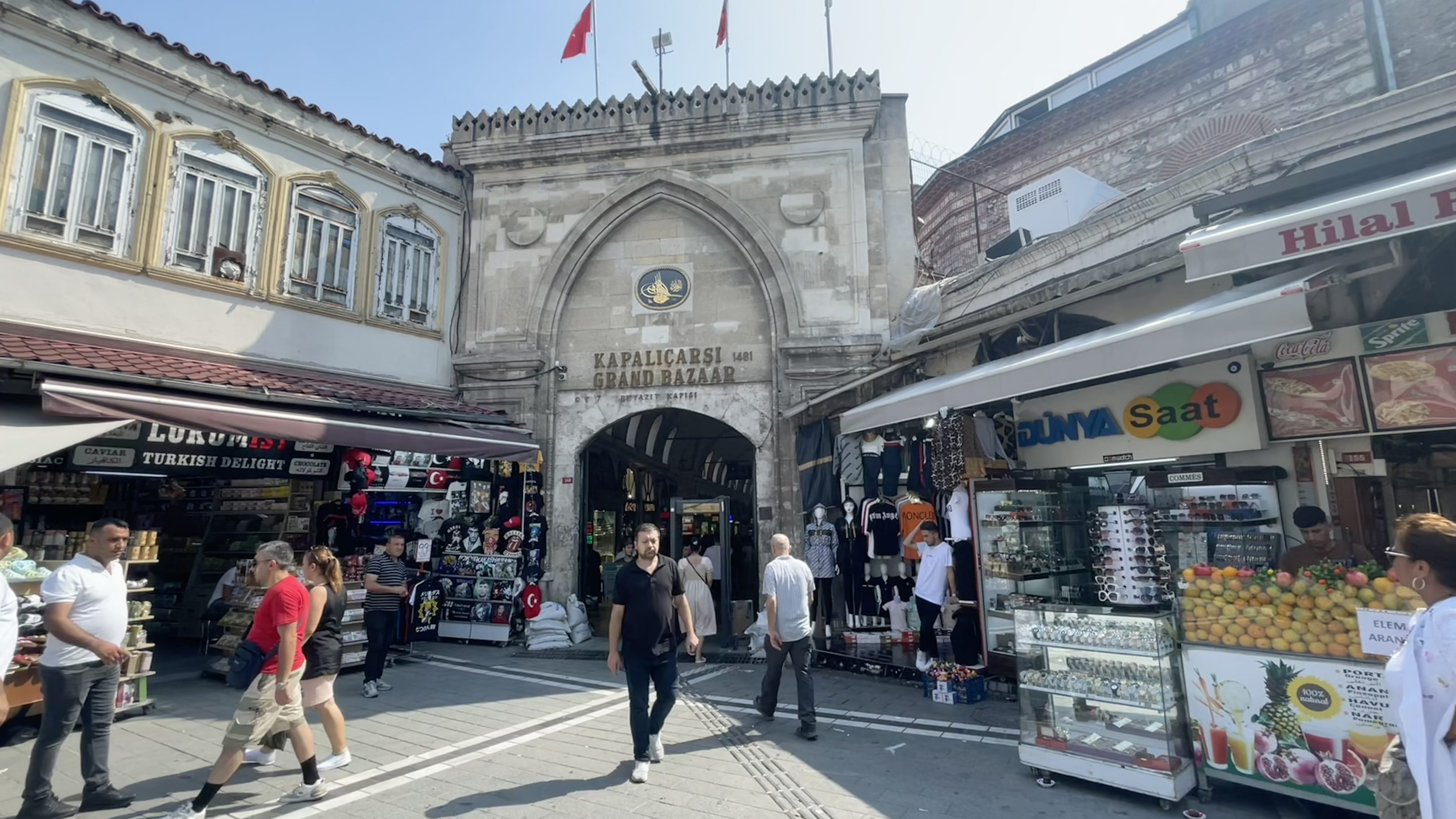 Entrance gate to the Grand Bazaar (Kapalıçarşı) in Istanbul, Turkey, with people walking through the historic arched entryway.