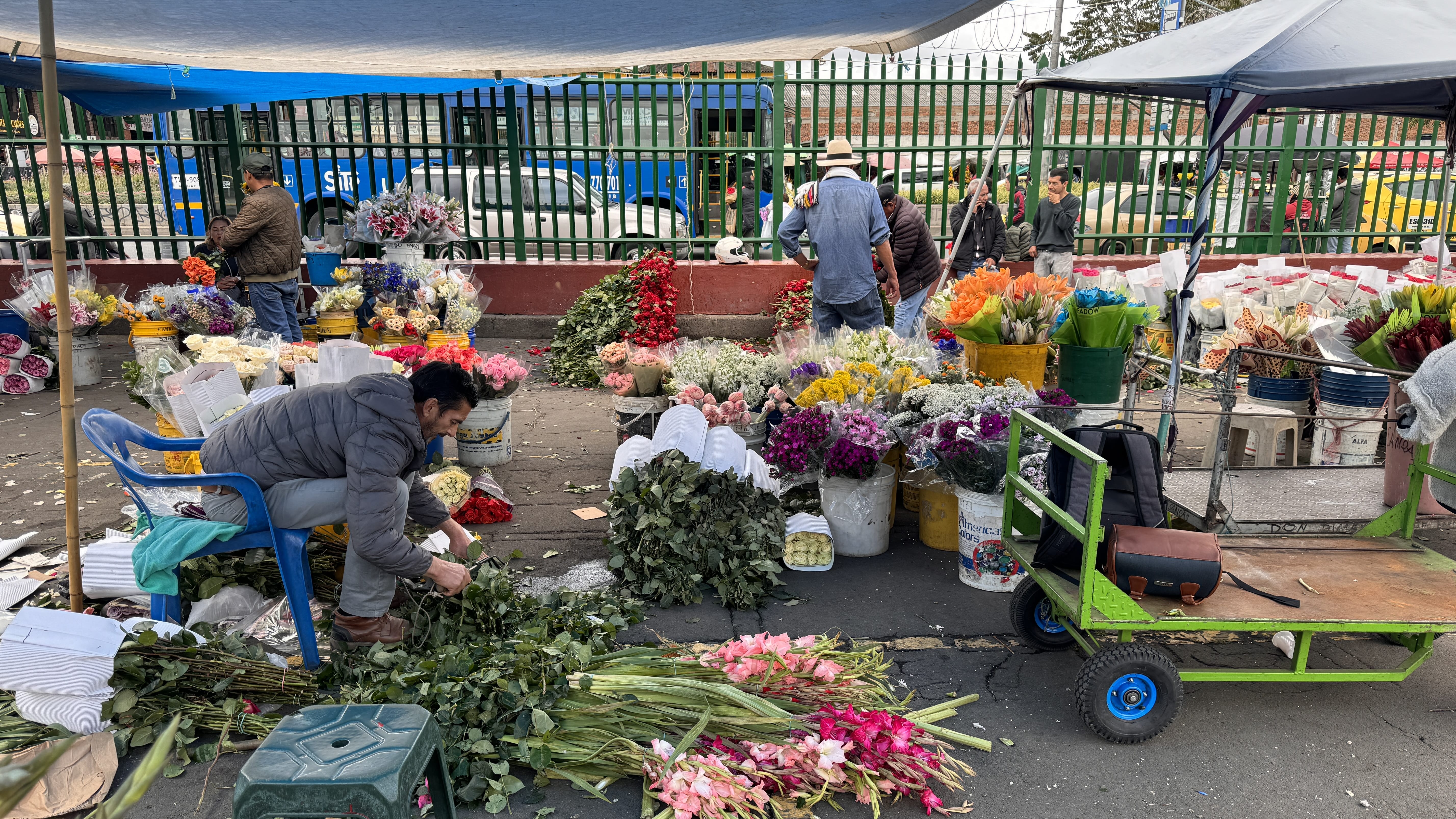 Vendors selling flowers at Paloquemao Market in Bogotá, with buckets of roses, lilies, and tropical blooms. (2 Days in Bogotá)