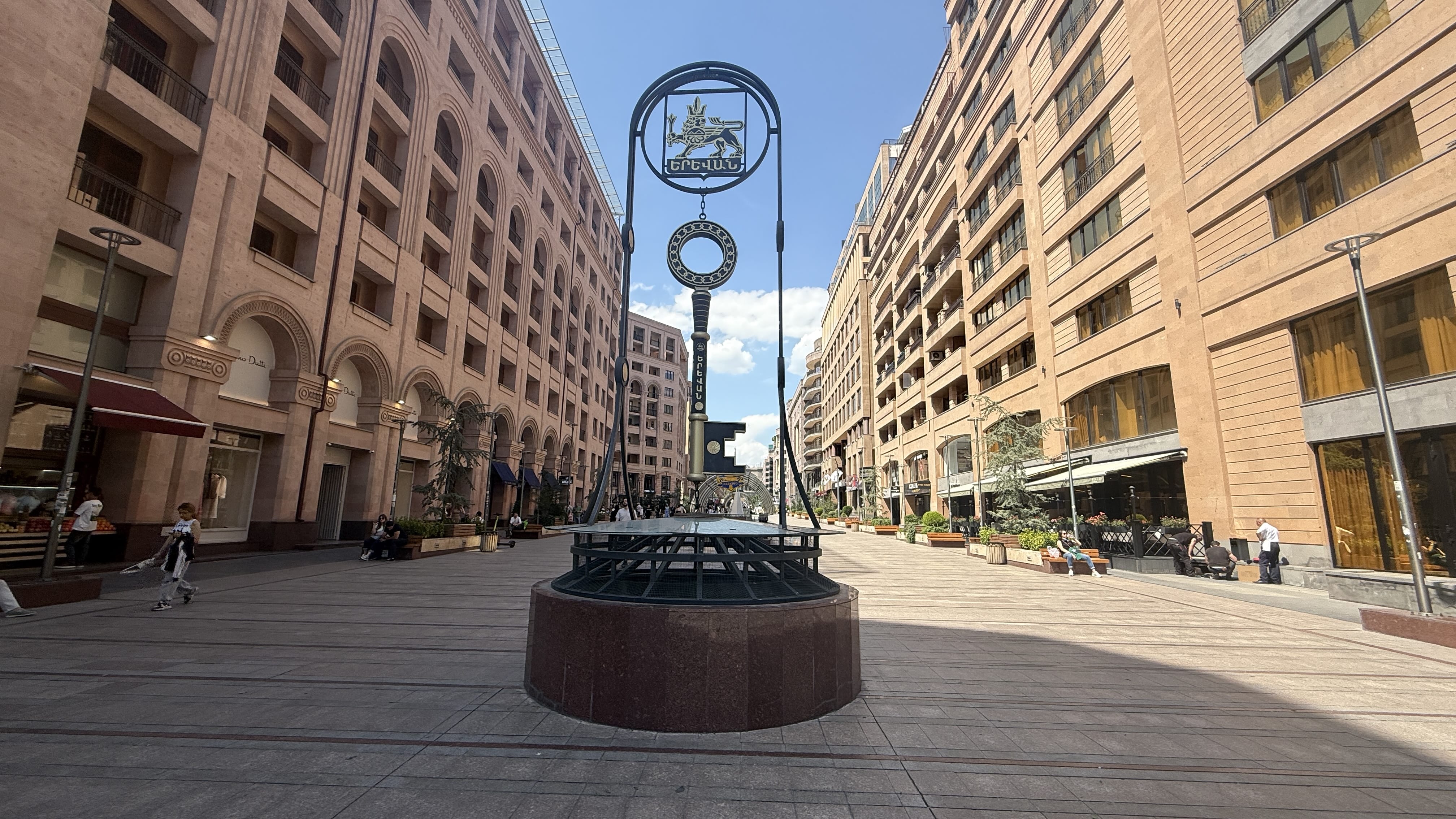 Wide pedestrian boulevard of Northern Avenue in Yerevan, Armenia, lined with modern buildings and shops.