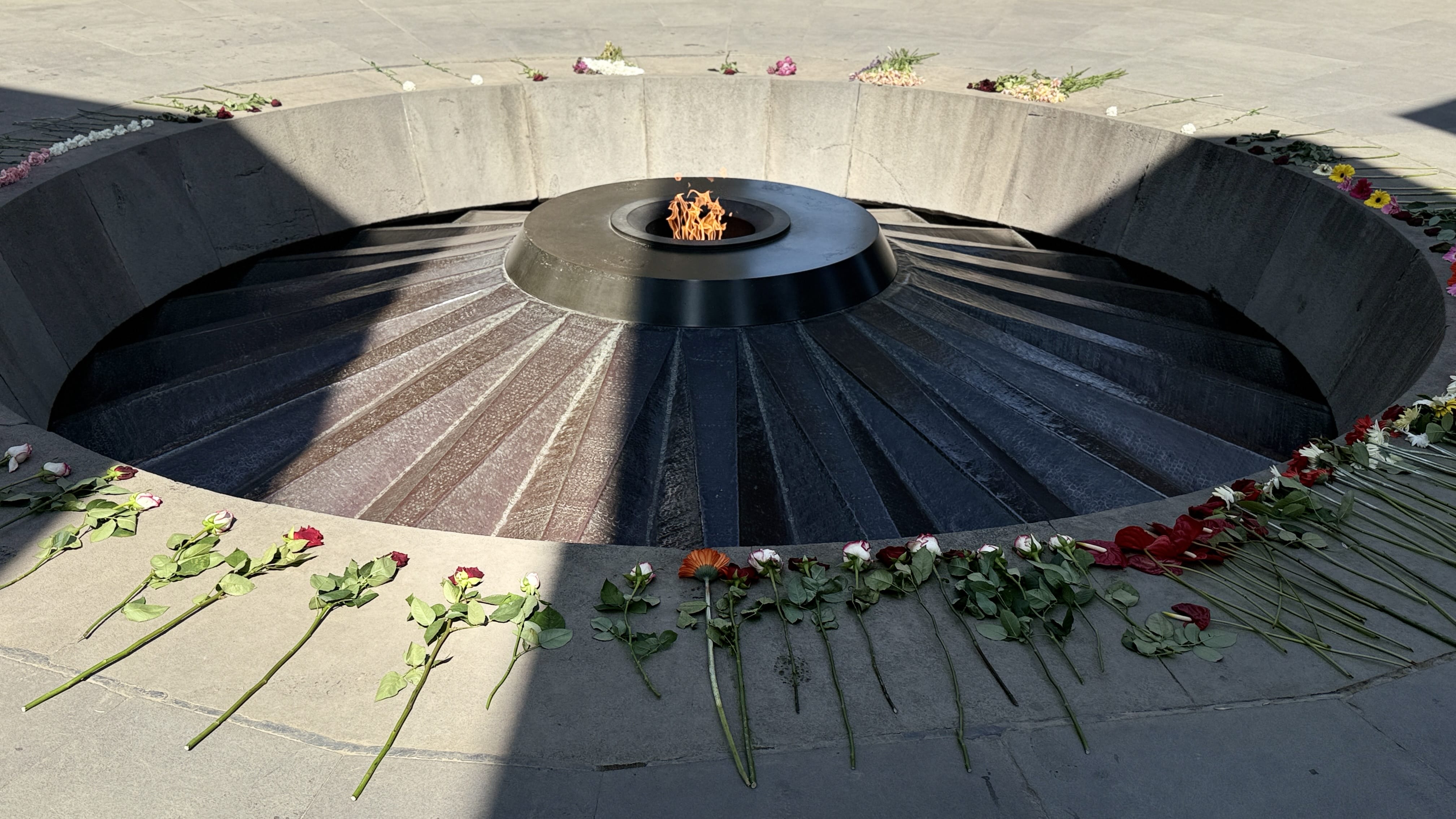 Eternal flame surrounded by flowers at the Armenian Genocide Memorial in Yerevan, Armenia.