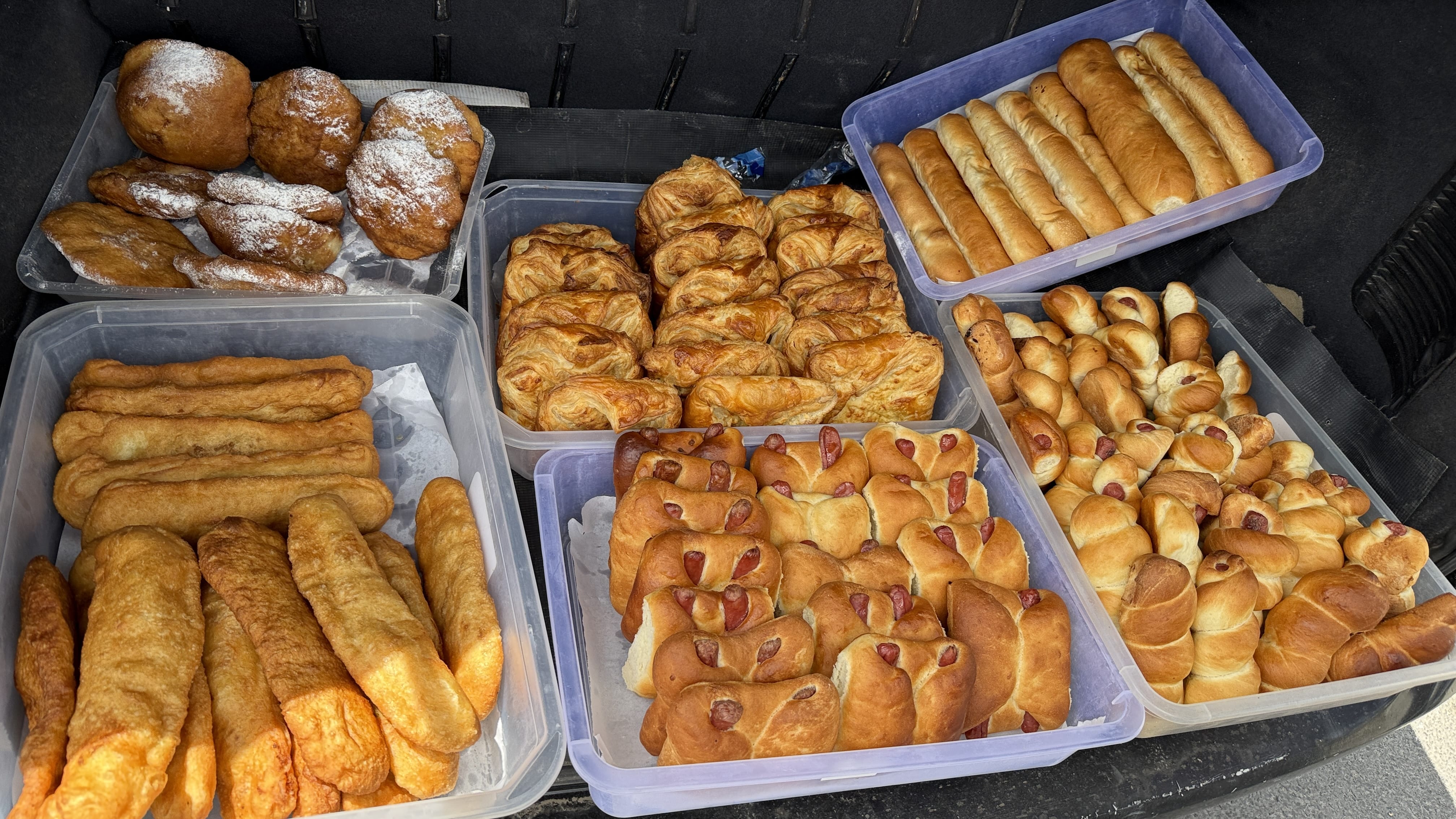 Assorted Armenian pastries and breads in plastic trays, seen on a road trip during seven days in Armenia.