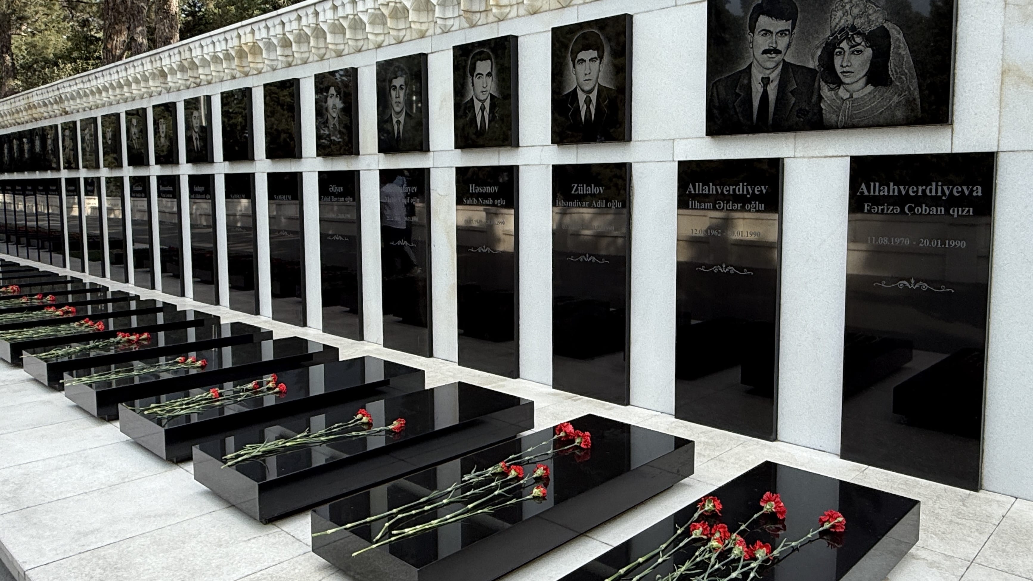 Black marble graves with red carnations at Martyrs’ Lane in Baku, Azerbaijan — 7 Days in Azerbaijan memorial photo.