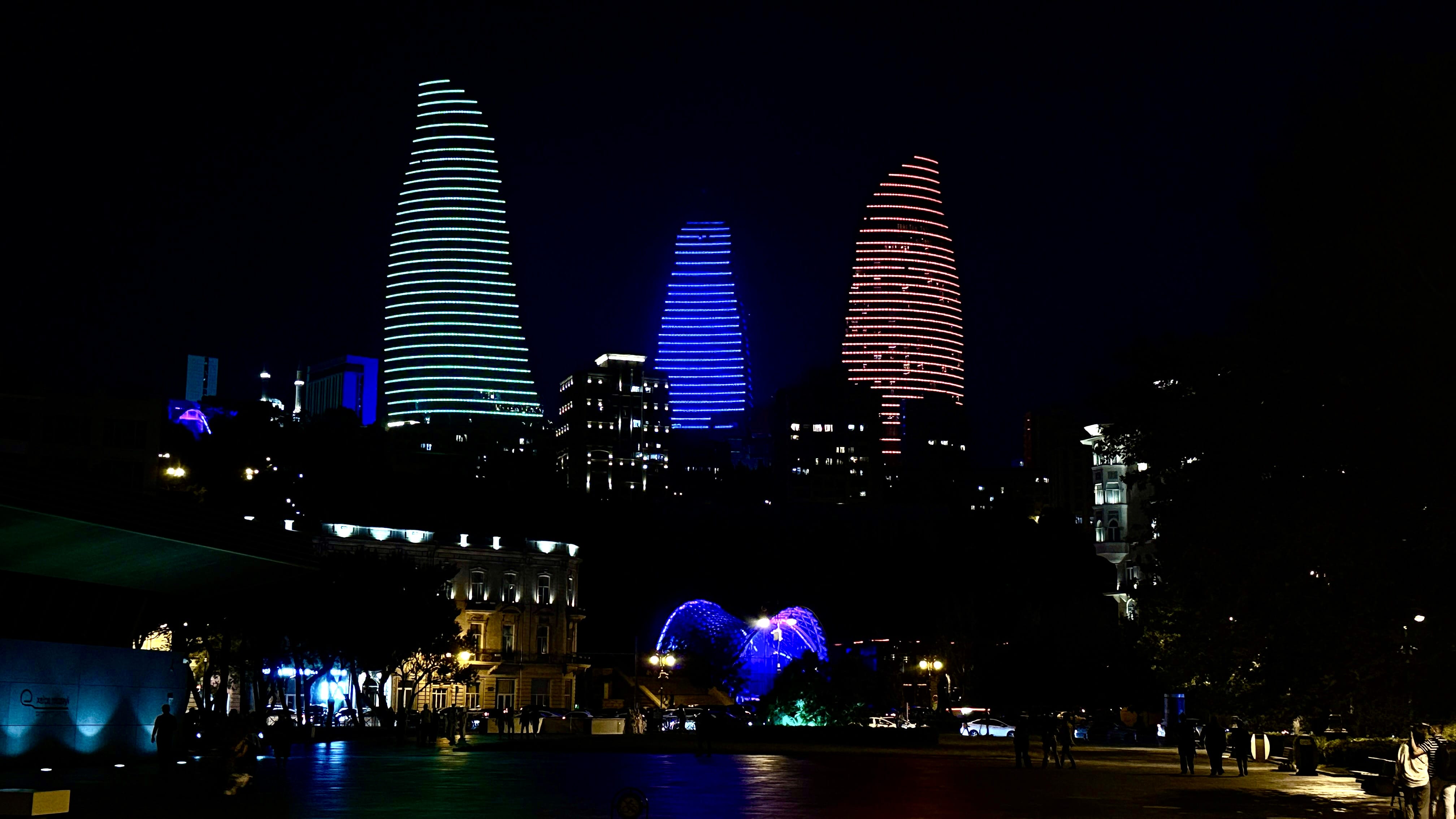 Baku Flame Towers illuminated in red, blue, and green lights at night — 7 Days in Azerbaijan city skyline photo.