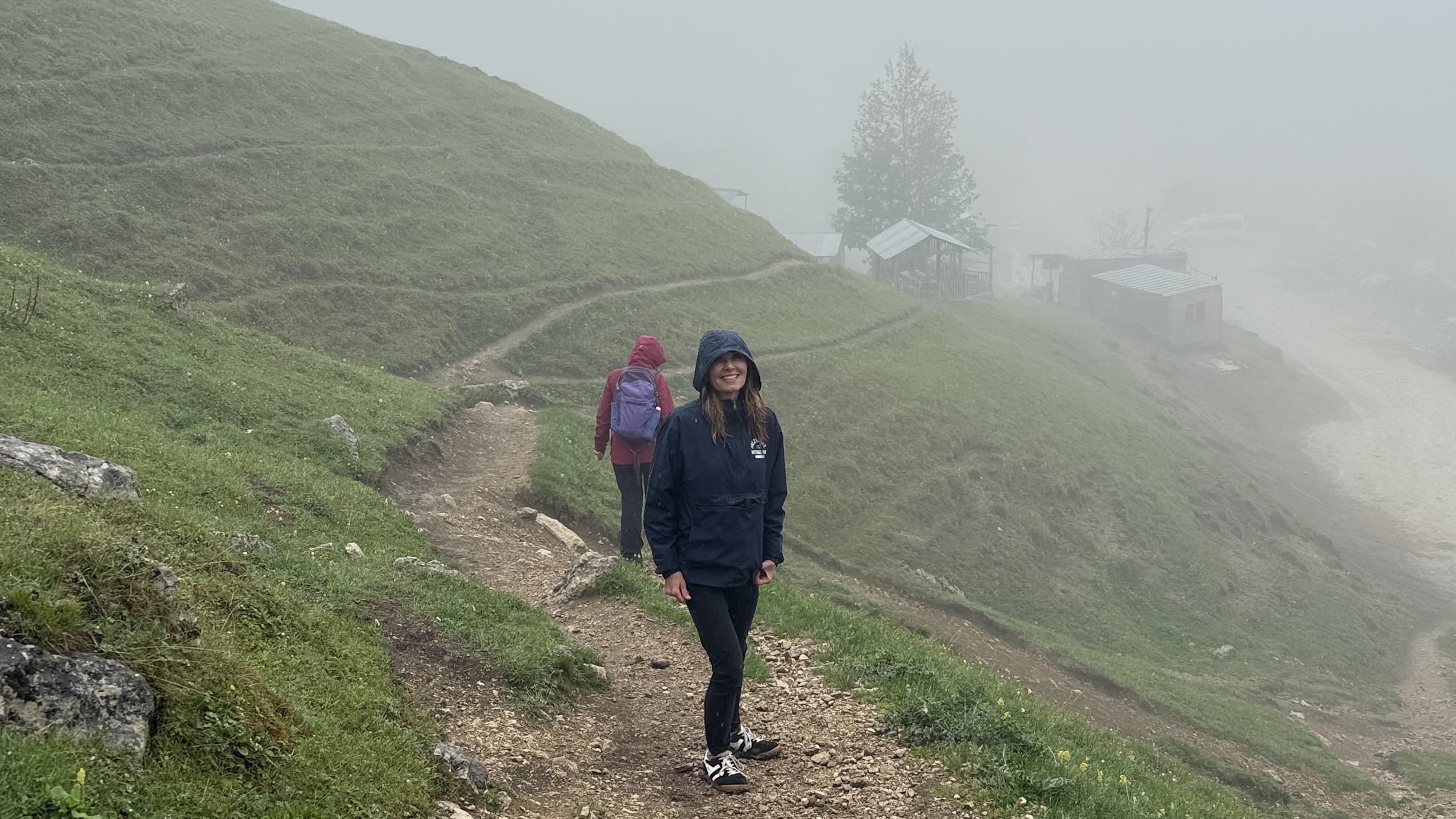 Traveler on foggy trail to Afurja Waterfall in Laza village, Azerbaijan, during 7 Days in Azerbaijan trip.