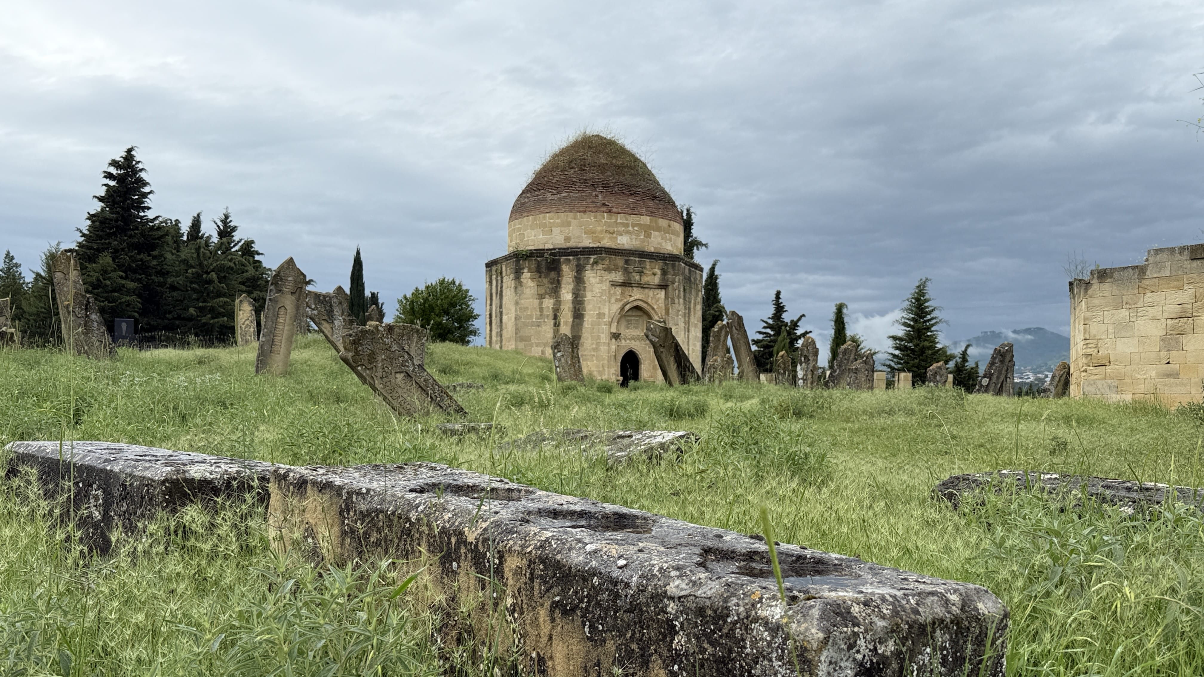 Yeddi Gumbaz Mausoleum in Shamakhi, Azerbaijan, surrounded by old gravestones during 7 Days in Azerbaijan.