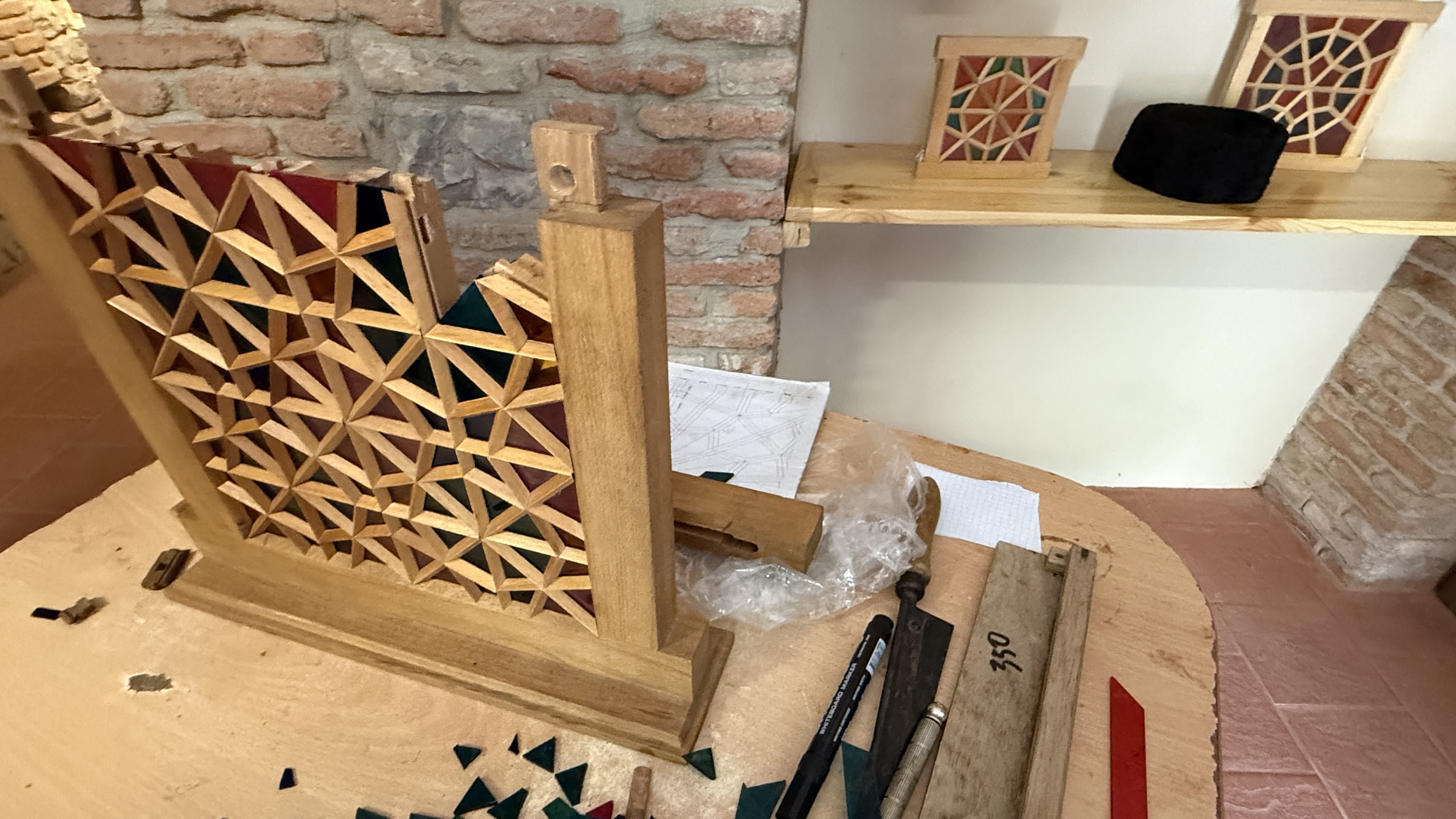 Small handmade shebeke stained-glass frames displayed in a workshop in Shaki, Azerbaijan—7 Days in Azerbaijan