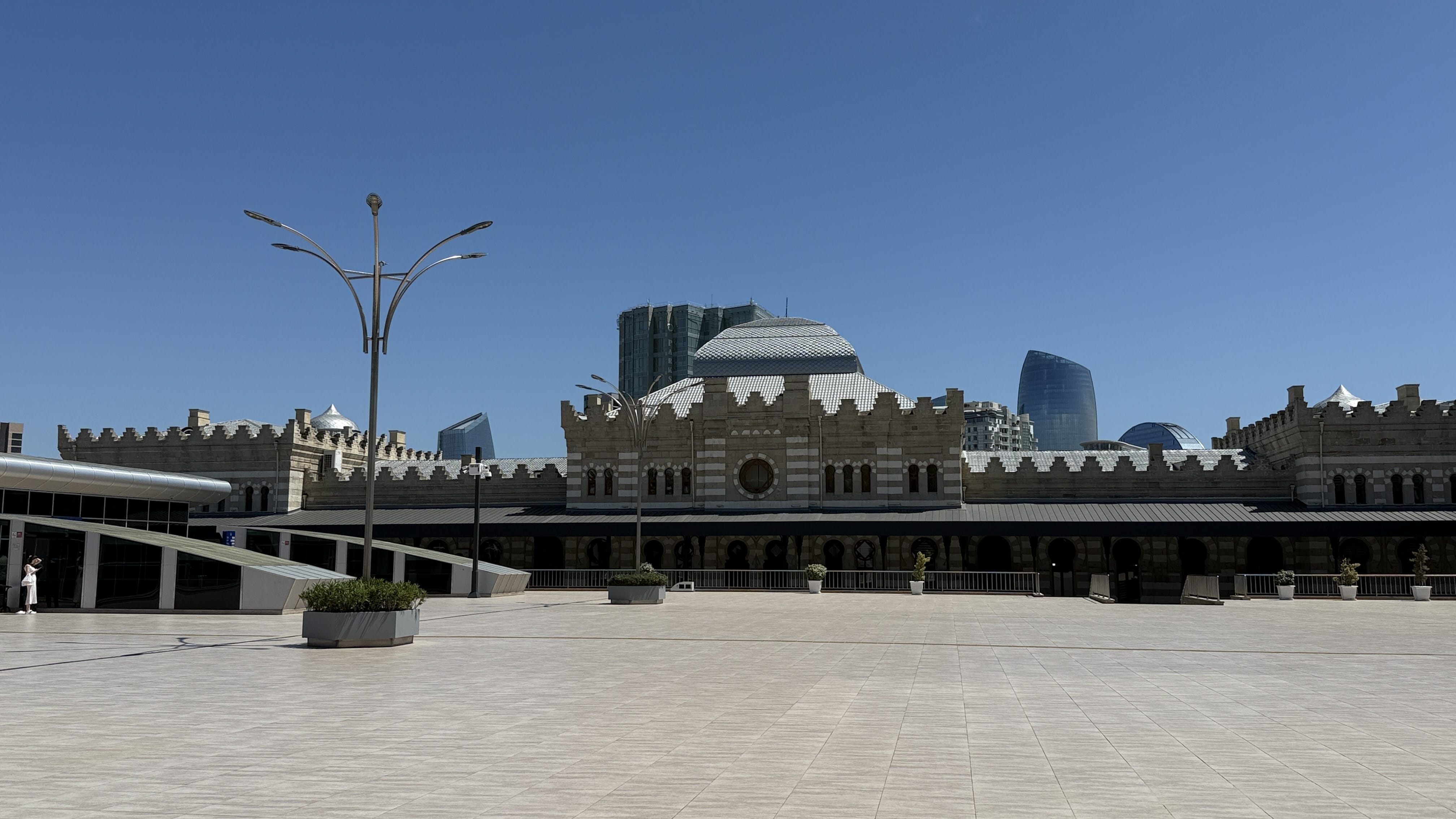 Exterior of 28 May Metro Station in Baku with castle-like stone design under a bright blue sky — 2 Days in Baku metro architecture.