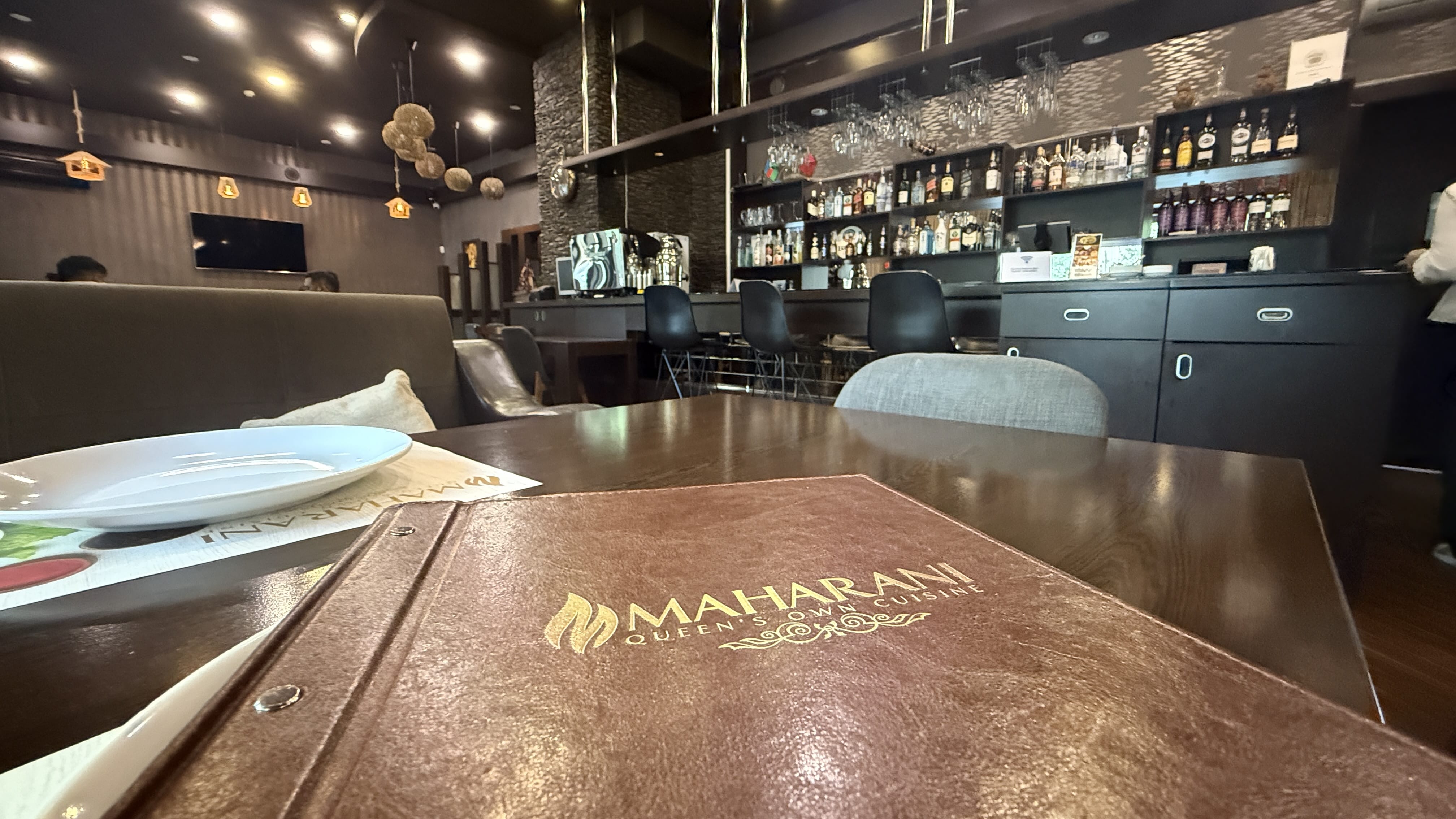 Interior of Maharani Restaurant in Baku with leather menu on the table — 2 Days in Baku dining experience.
