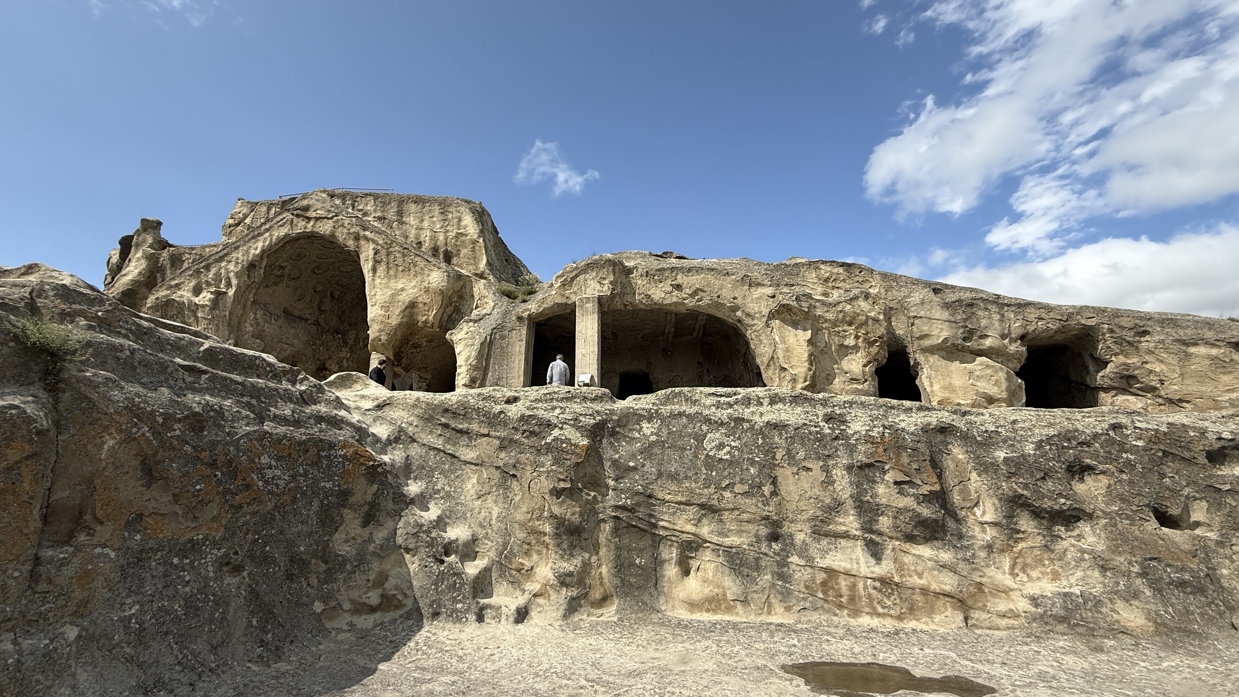 Rock-cut dwellings and carved chambers at Uplistsikhe, an ancient cave city in Georgia.
