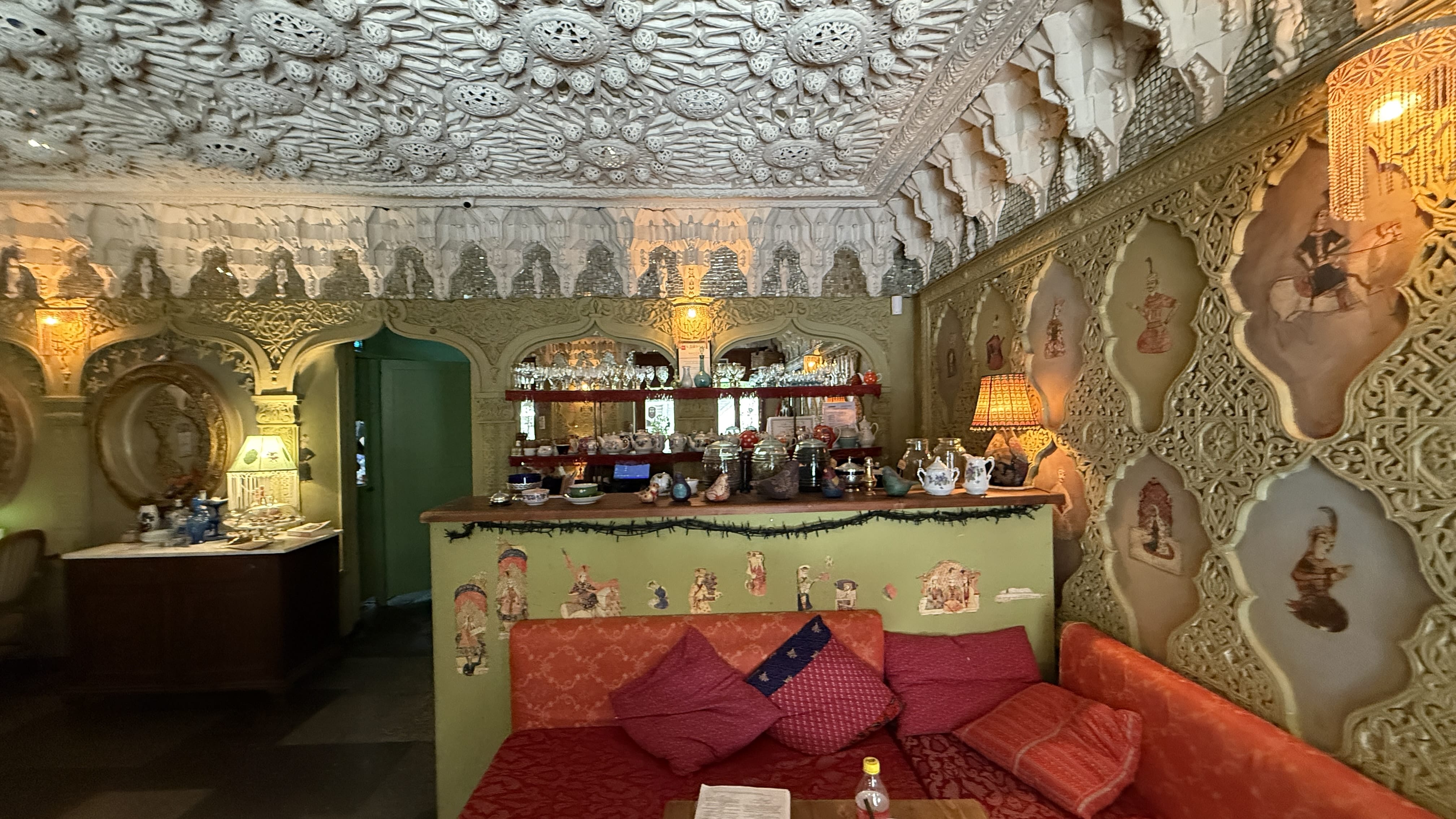 Ornate interior of Lilea restaurant in Tbilisi with carved plaster ceiling and decorative walls
