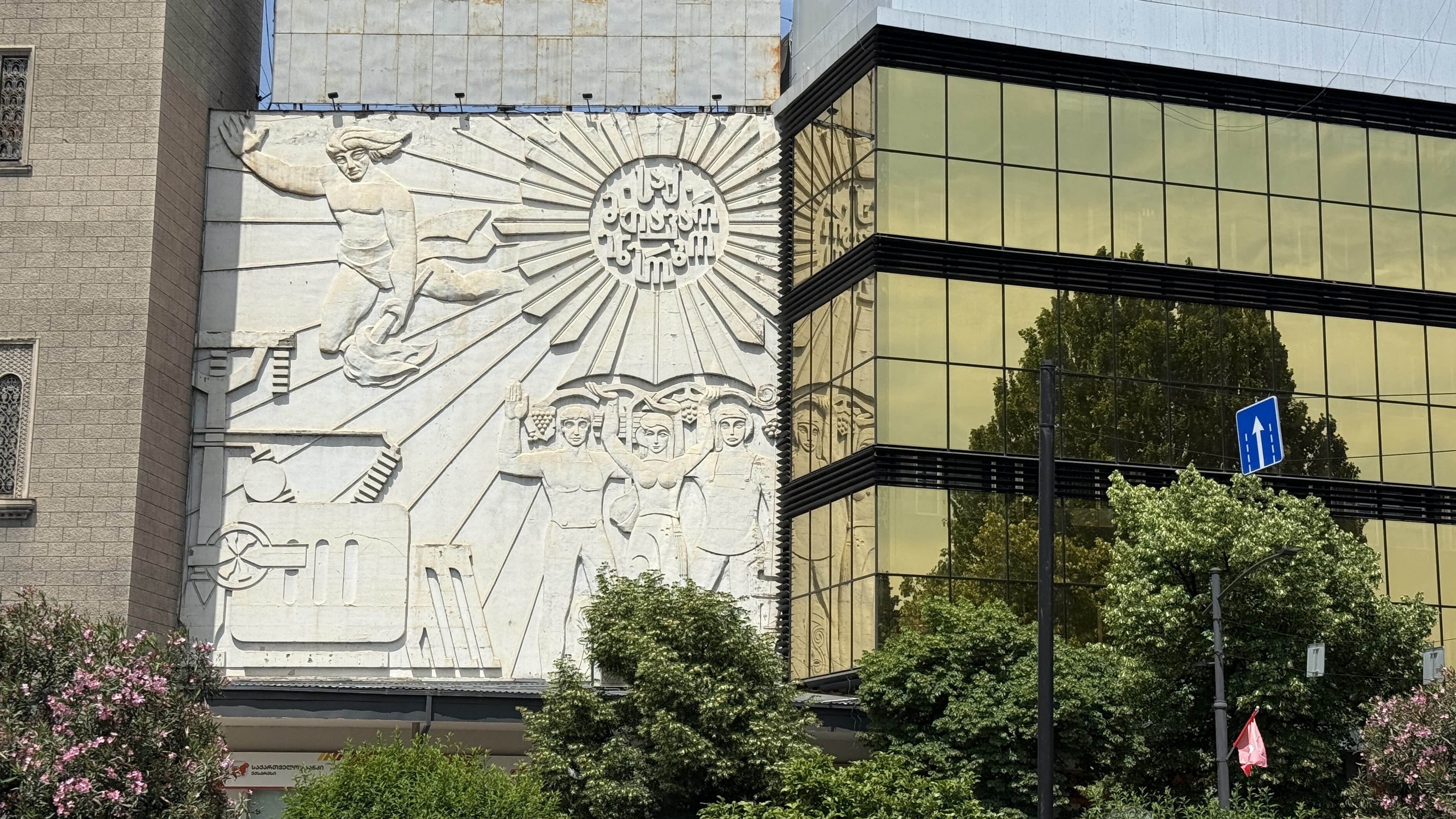 Soviet-era bas-relief sculpture on a building facade in Tbilisi, Georgia