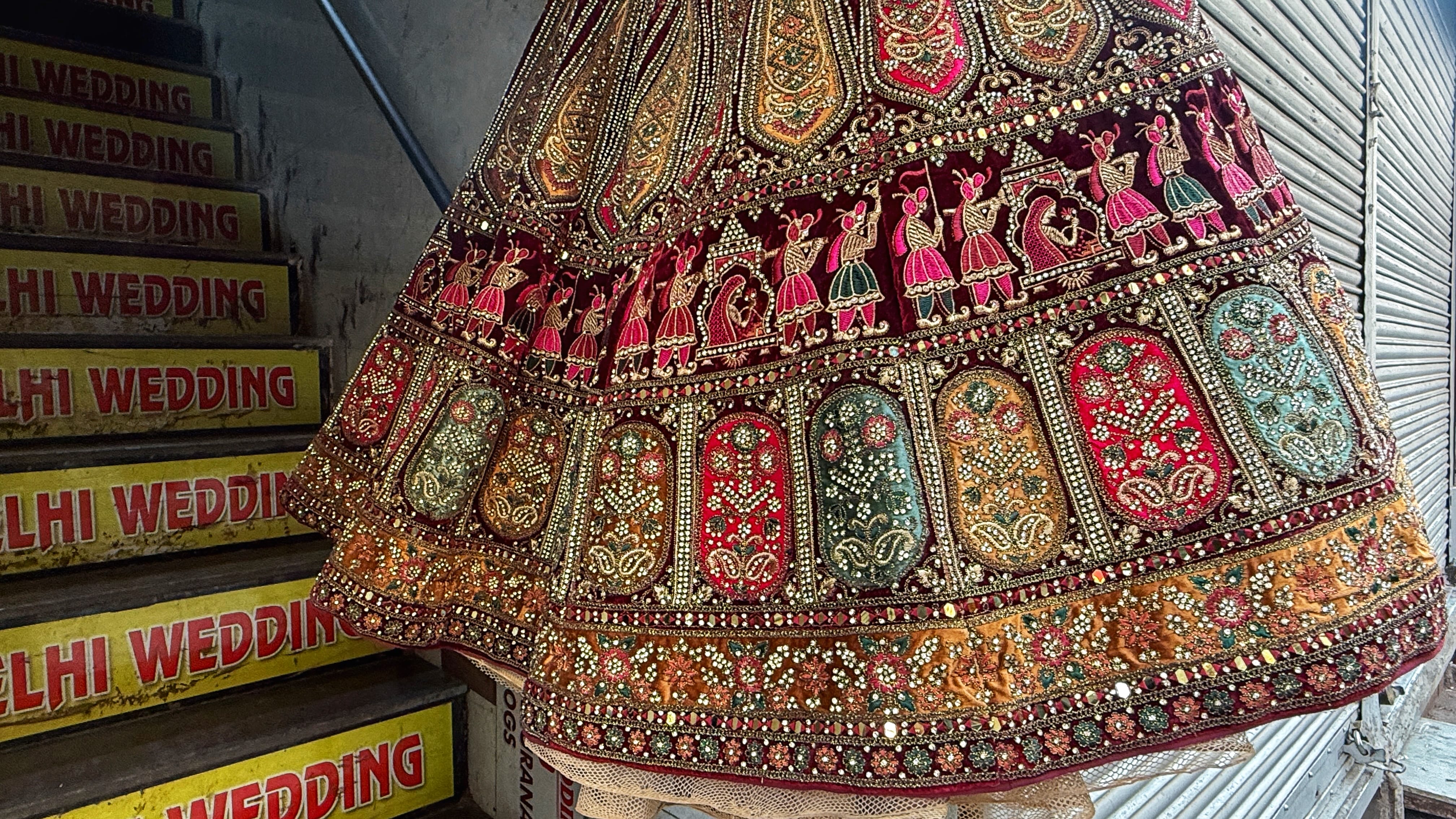 Bridal lehenga covered in intricate hand embroidery seen during my 2 Days in Delhi walking through the wedding market lanes near Chandni Chowk.