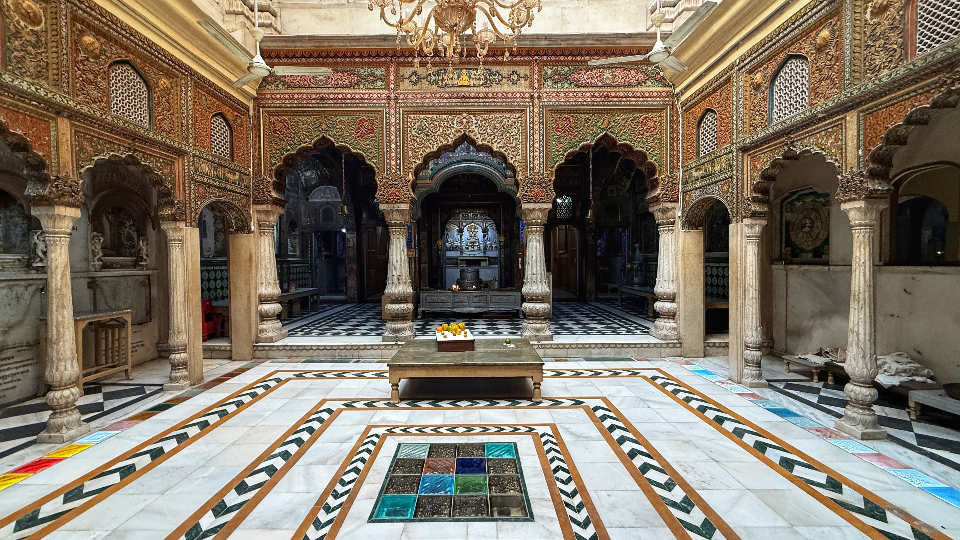 Ornate Jain temple courtyard visited during my 2 Days in Delhi itinerary, featuring arches, carved pillars, and patterned marble floors.