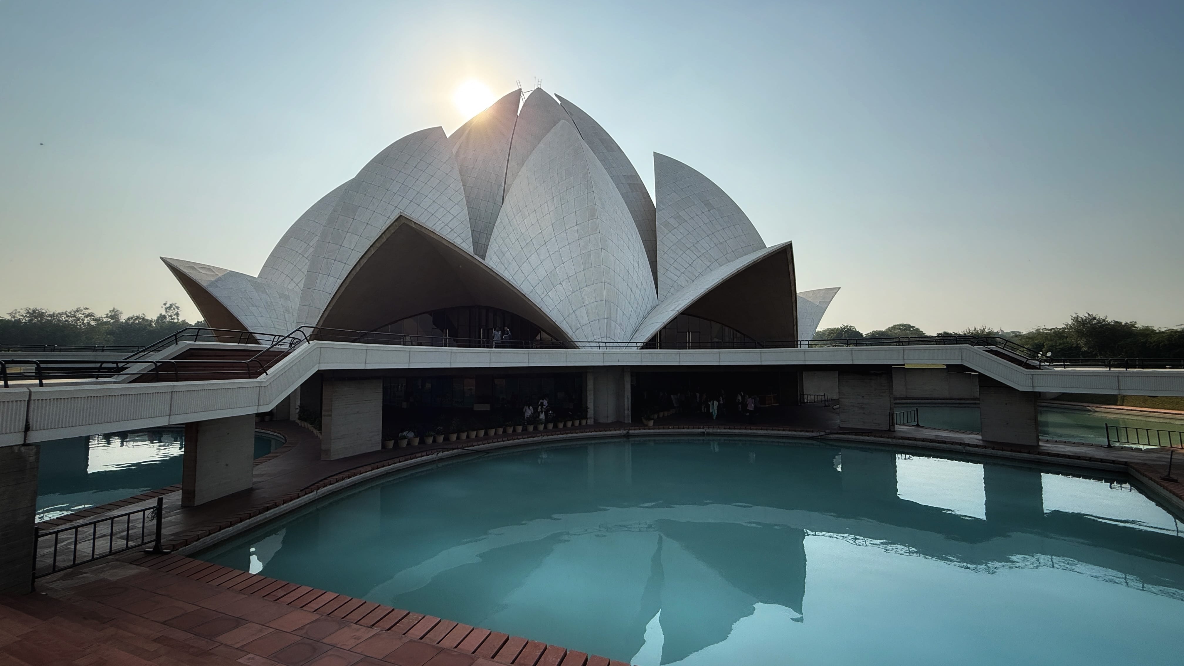 Lotus Temple in Delhi, India, showing the white marble flower-shaped structure reflected in the surrounding pool of turquoise water —2 Days in Delhi.