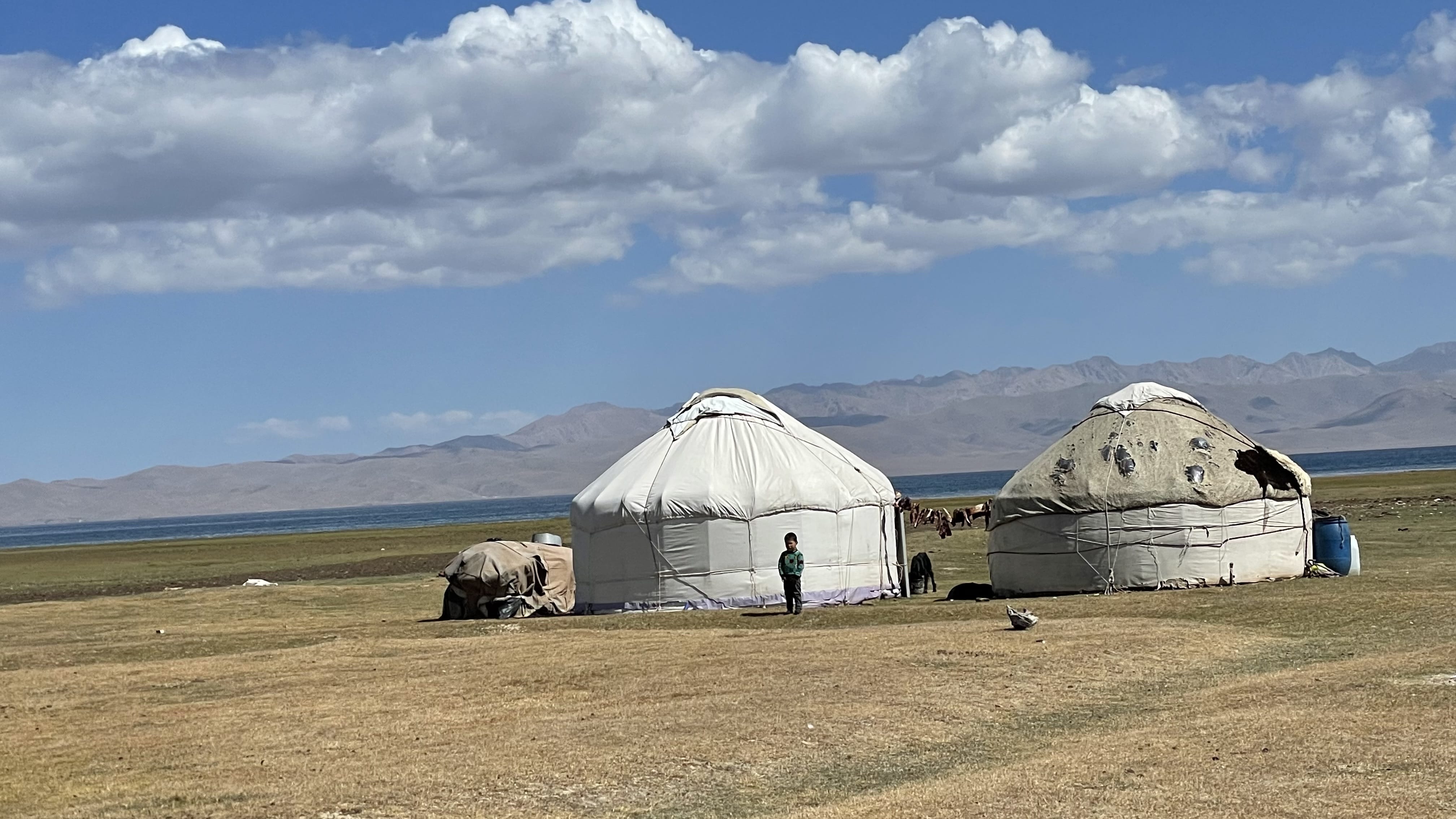 Nomadic family yurt at Song Kol Lake with meat drying on a rope outside, Kyrgyzstan