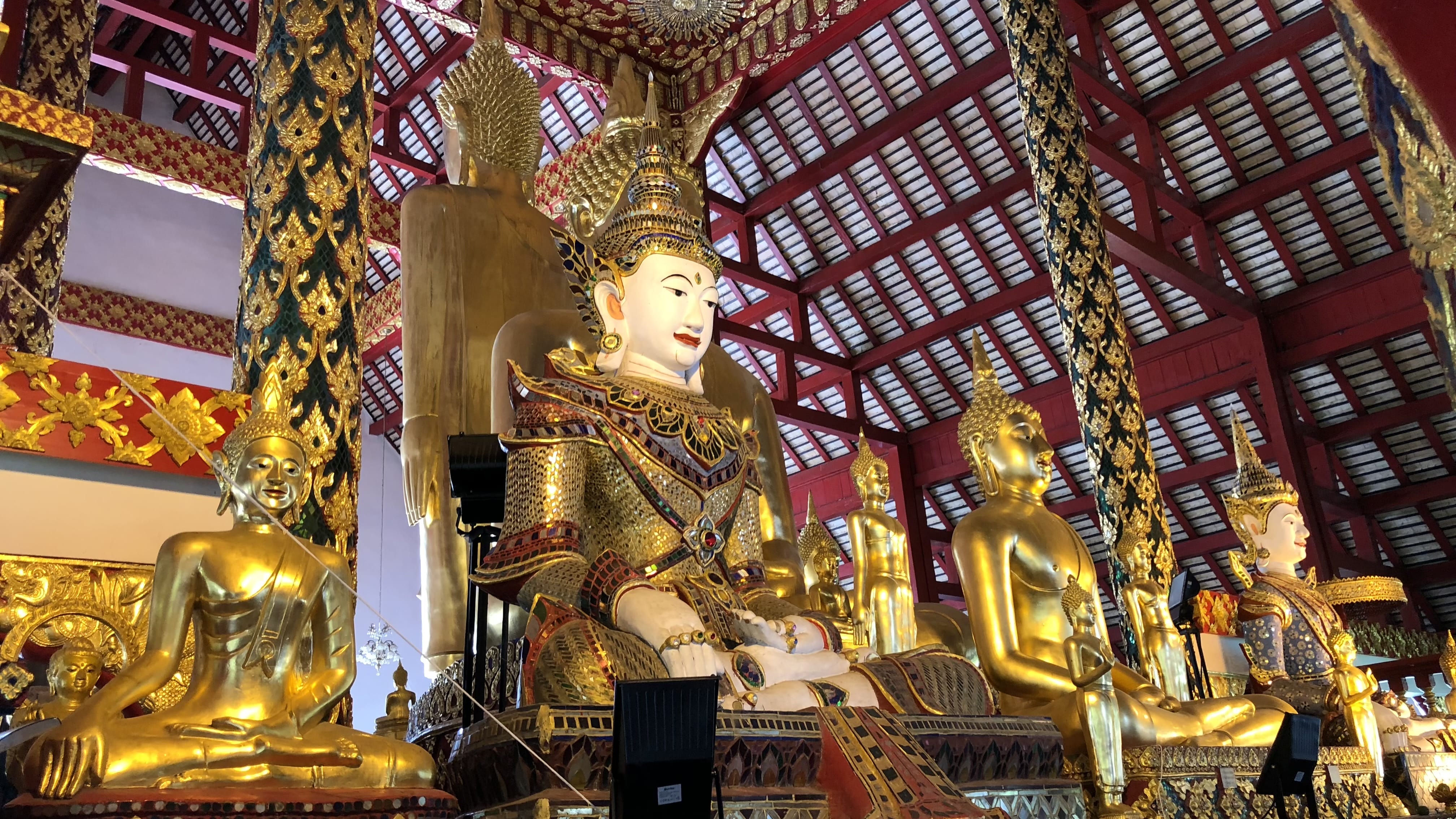 Ornate seated Buddha statues inside the main hall at Mahachulalongkornrajavidyalaya University near Chiang Mai, Thailand.