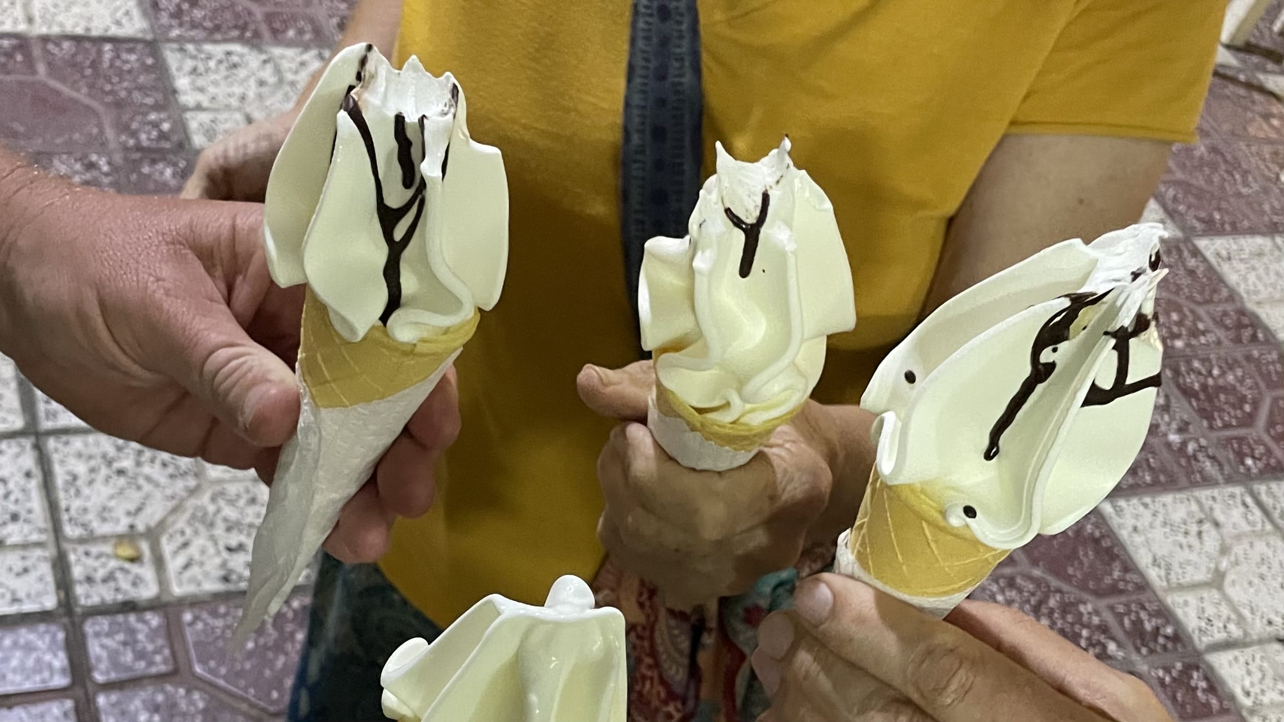 Custard-style ice cream cones topped with soft vanilla swirls and chocolate drizzle in Khujand, Tajikistan, photographed during a 3 days in Khujand, Tajikistan itinerary.