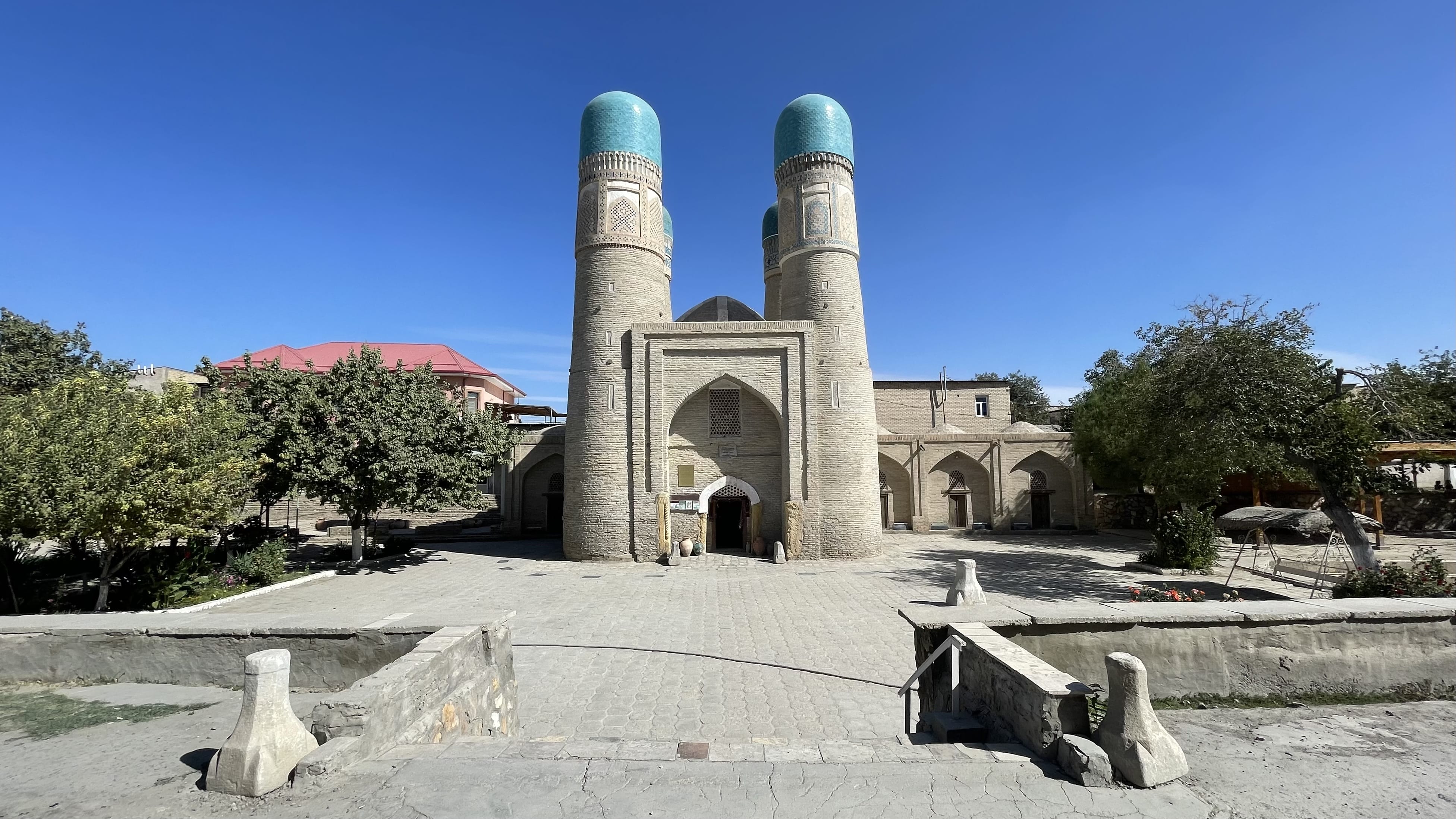 Chor Minor in Bukhara, Uzbekistan, with twin turquoise-domed towers at the entrance to a historic complex, photographed during a 4 days in Uzbekistan itinerary.