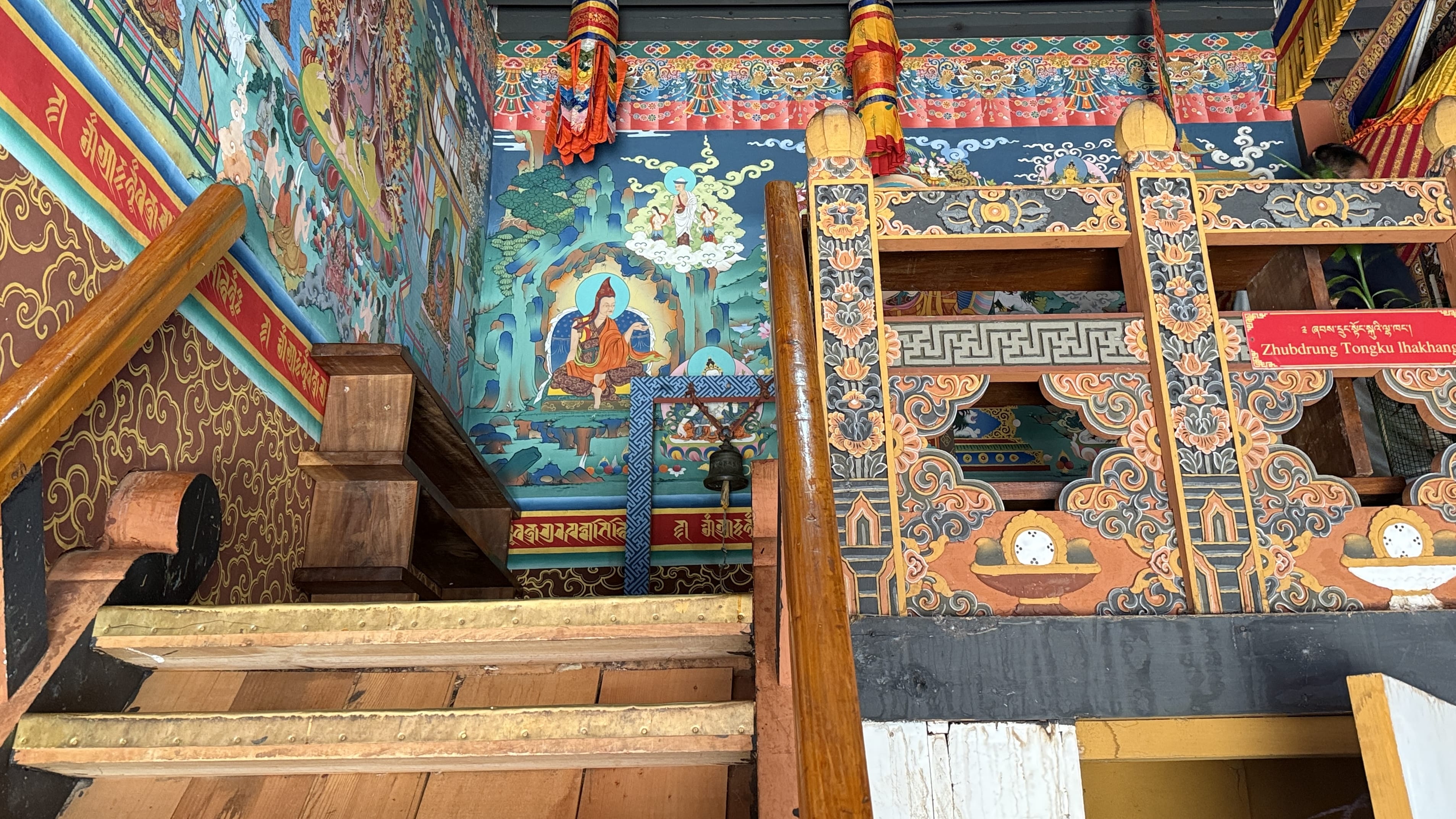 11 Days in Bhutan: painted stairway inside Wangdue Phodrang Dzong leading to Goen Gompa, with colorful Buddhist murals and carved wood details.