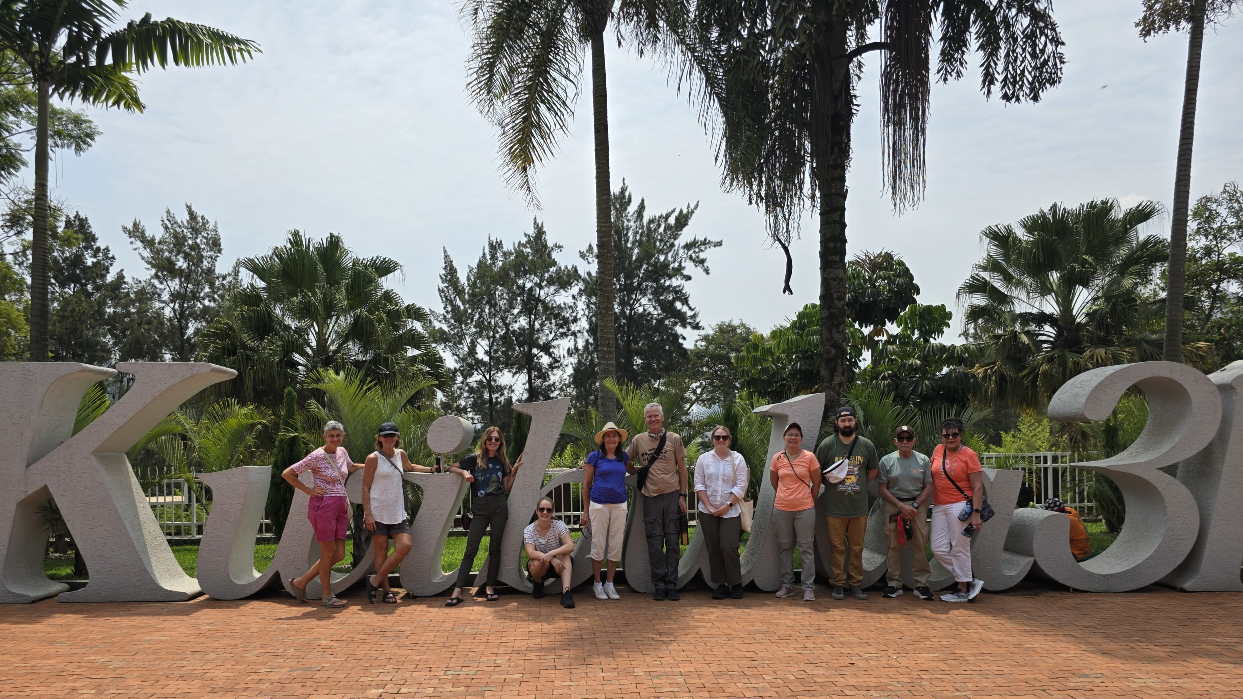 Travel group posing at the Kigali sign in Rwanda