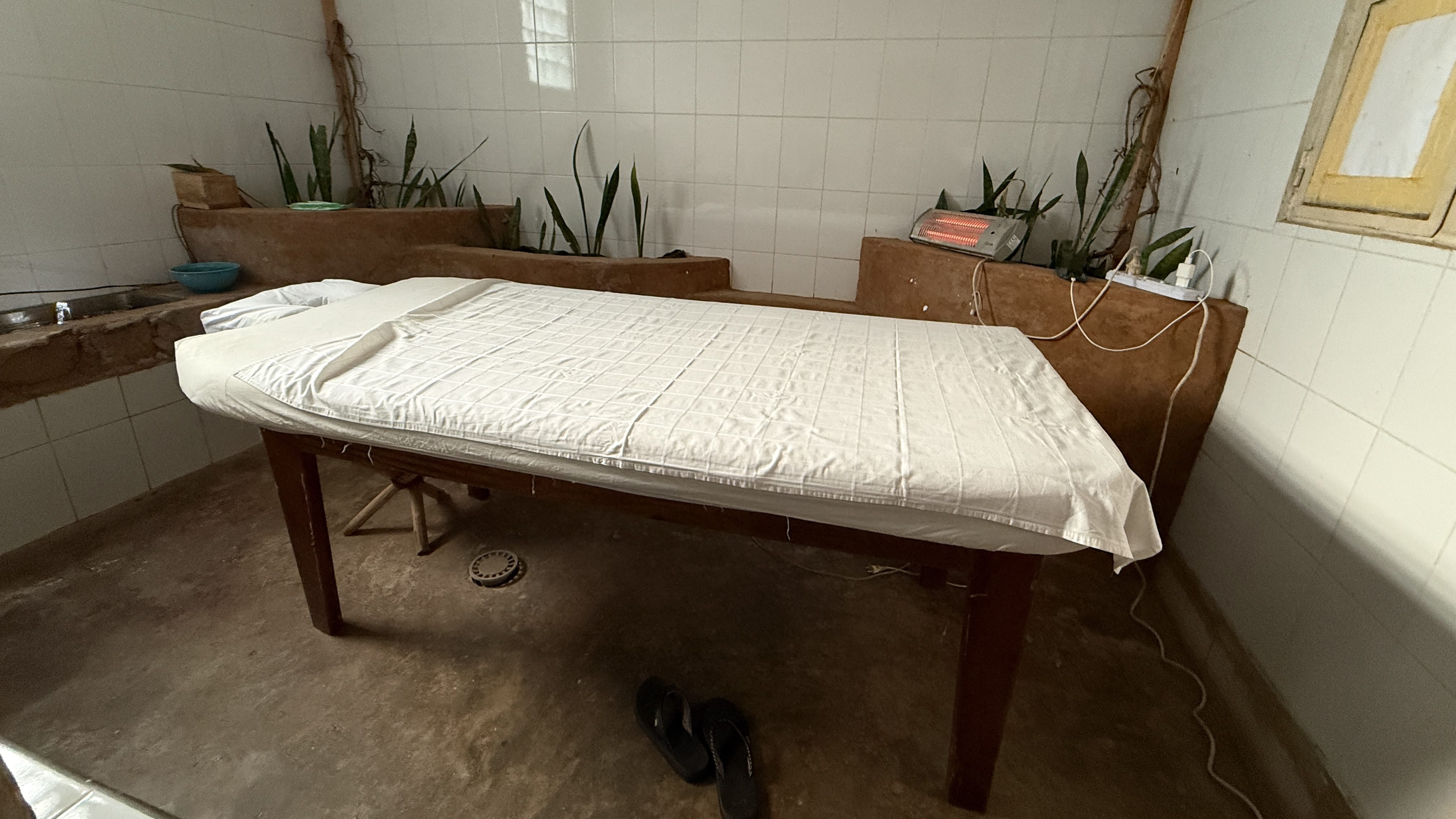 Simple massage table inside a spa room at La Locanda in Musanze, Rwanda, after hiking to Dian Fossey’s Karisoke Research Camp.