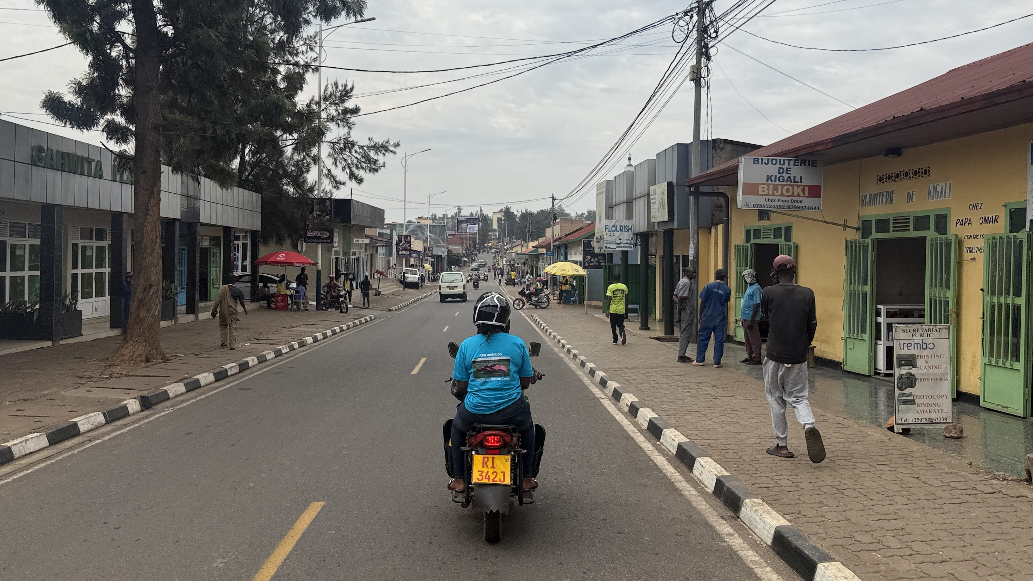 Motorcycle taxis riding through Kigali during a city tour in Rwanda