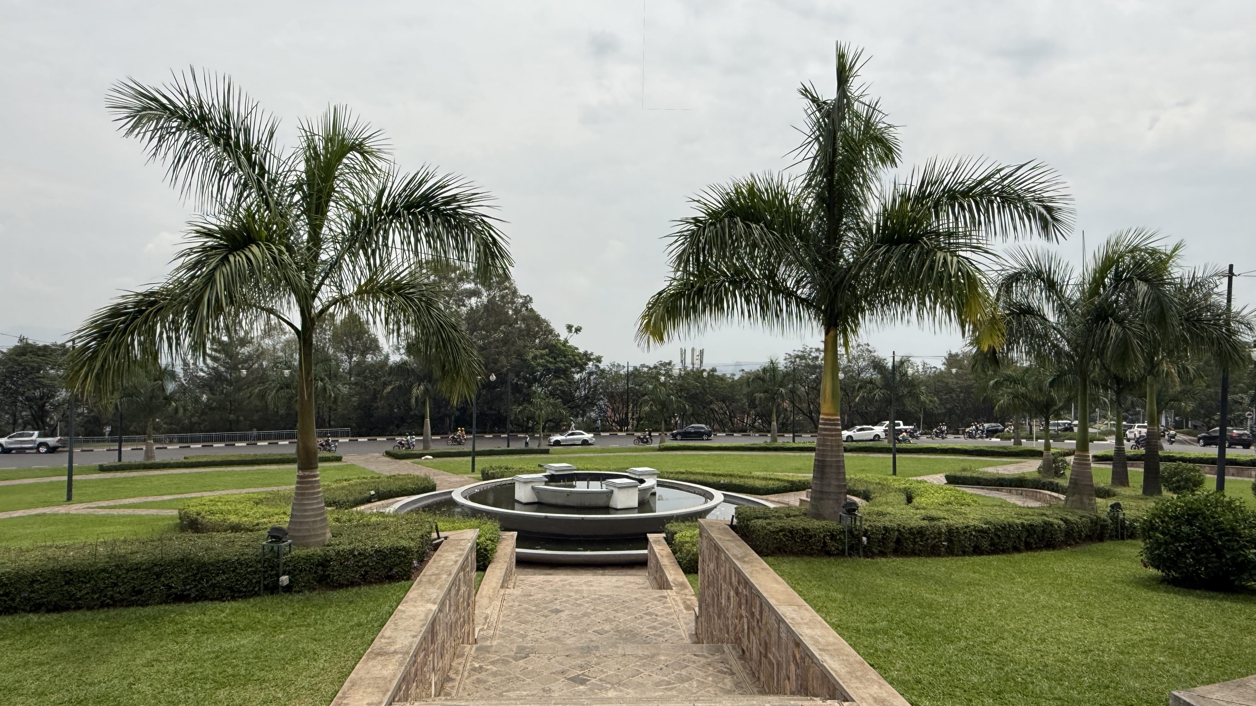 Palm trees and fountain at Place de l’Unité Nationale roundabout in Kigali Rwanda