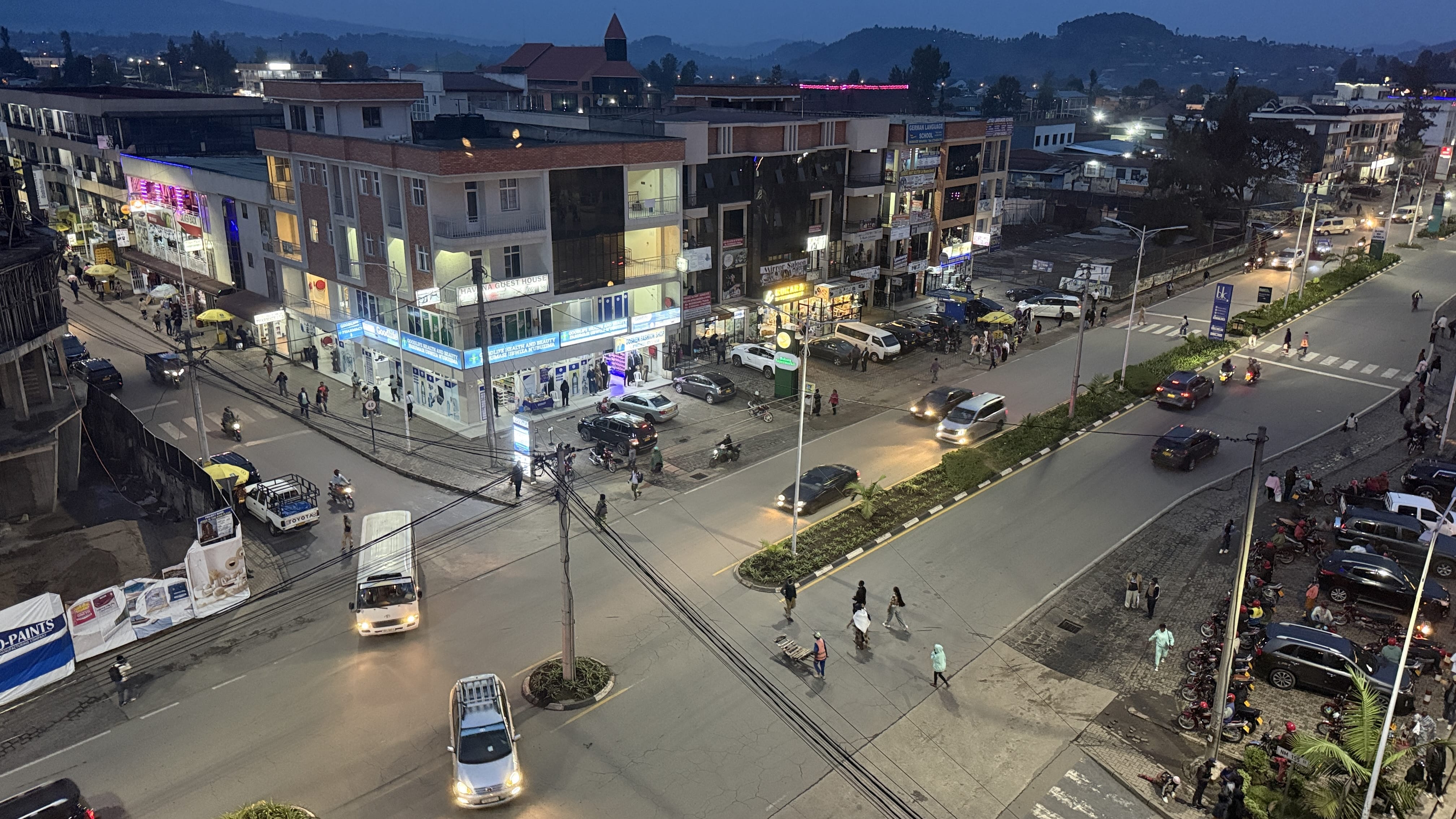 Evening street scene in Musanze Rwanda near Volcanoes National Park with traffic, shops and pedestrians- during my two nights in Musanze.