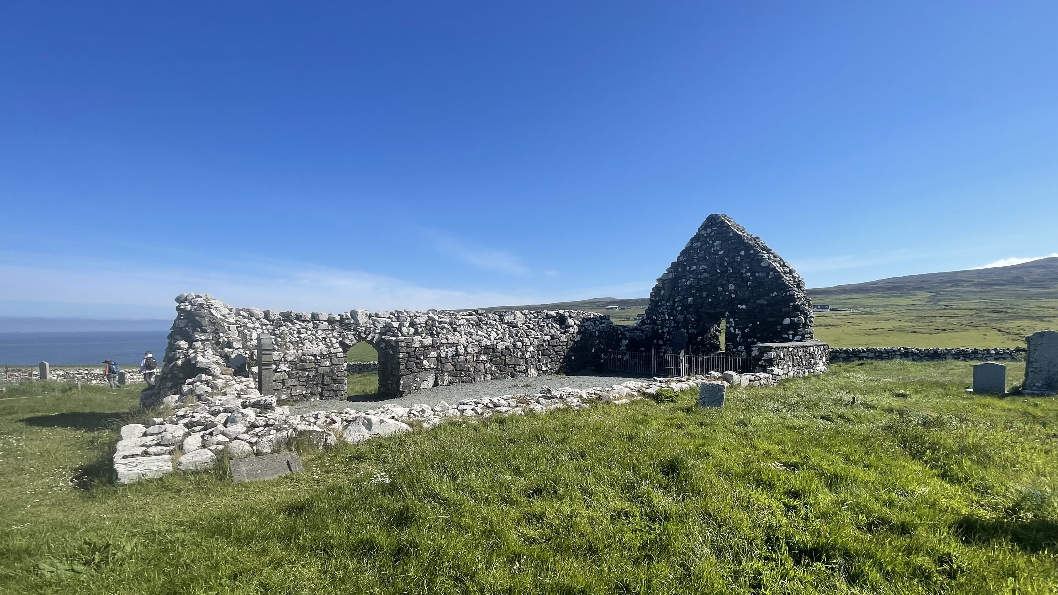 ruins of Trumpan Church on the Waternish Peninsula Isle of Skye with stone walls and grassy field