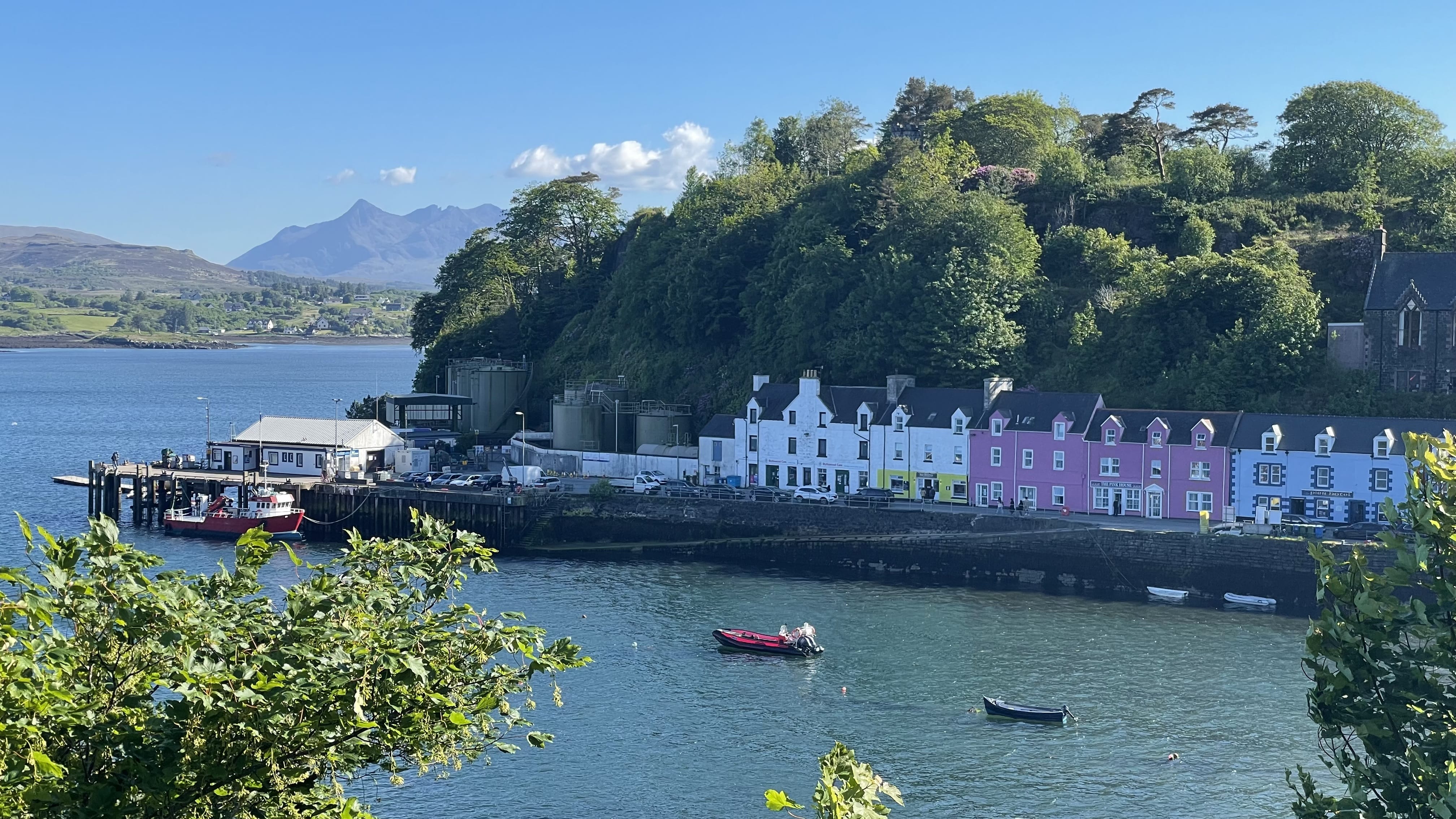 colorful houses along the harbor in Portree Isle of Skye with boats on the water