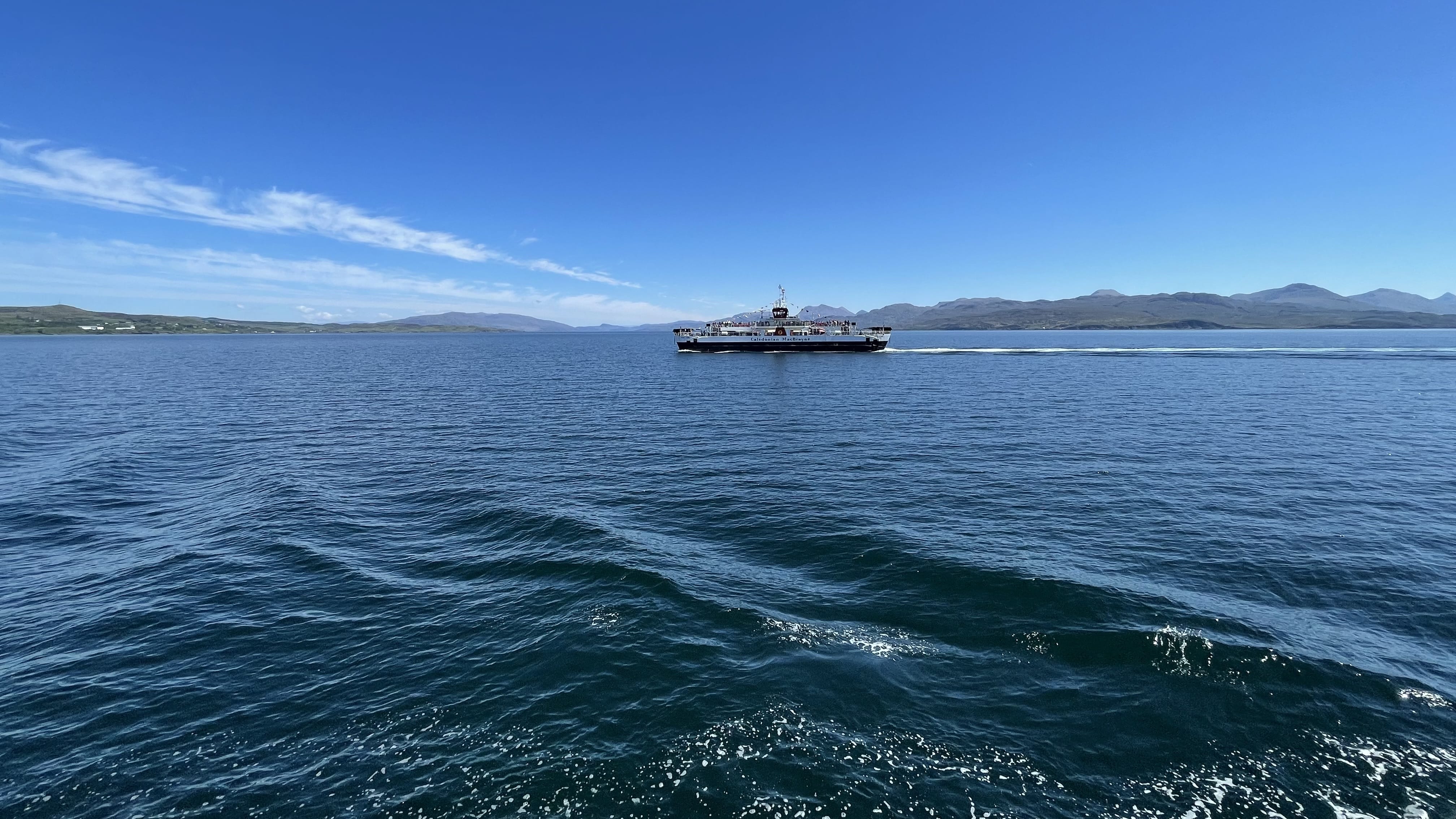 ferry crossing from Armadale to Mallaig with calm blue water and distant mountains
