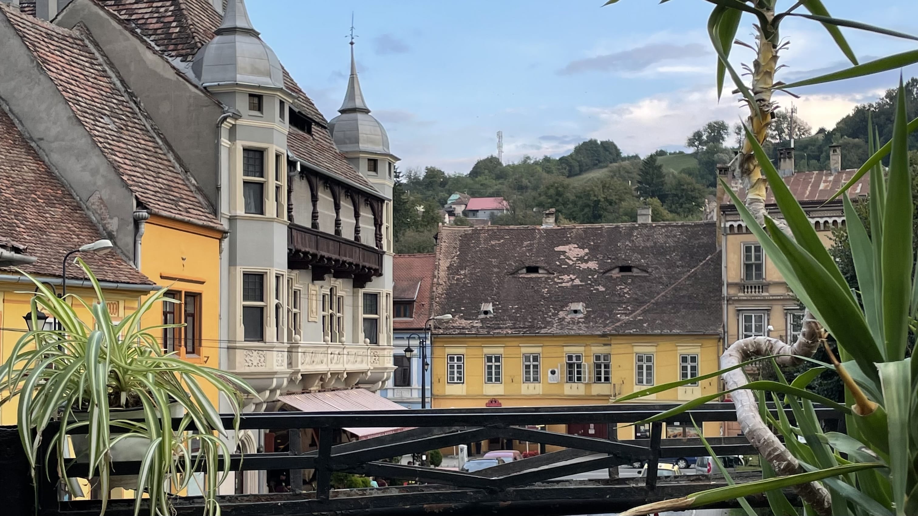 View of historic rooftops and colorful buildings in Sighișoara, Romania.